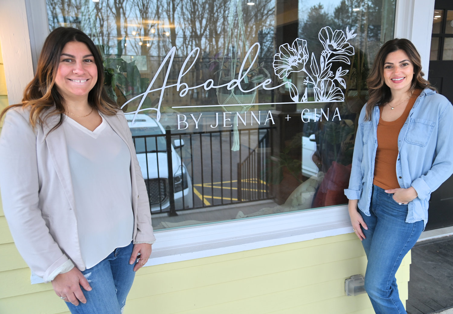 Jenna Rossi (left) and Gina Sangiacomo with their front window signage at Abode on Oxford Road in New Hartford.