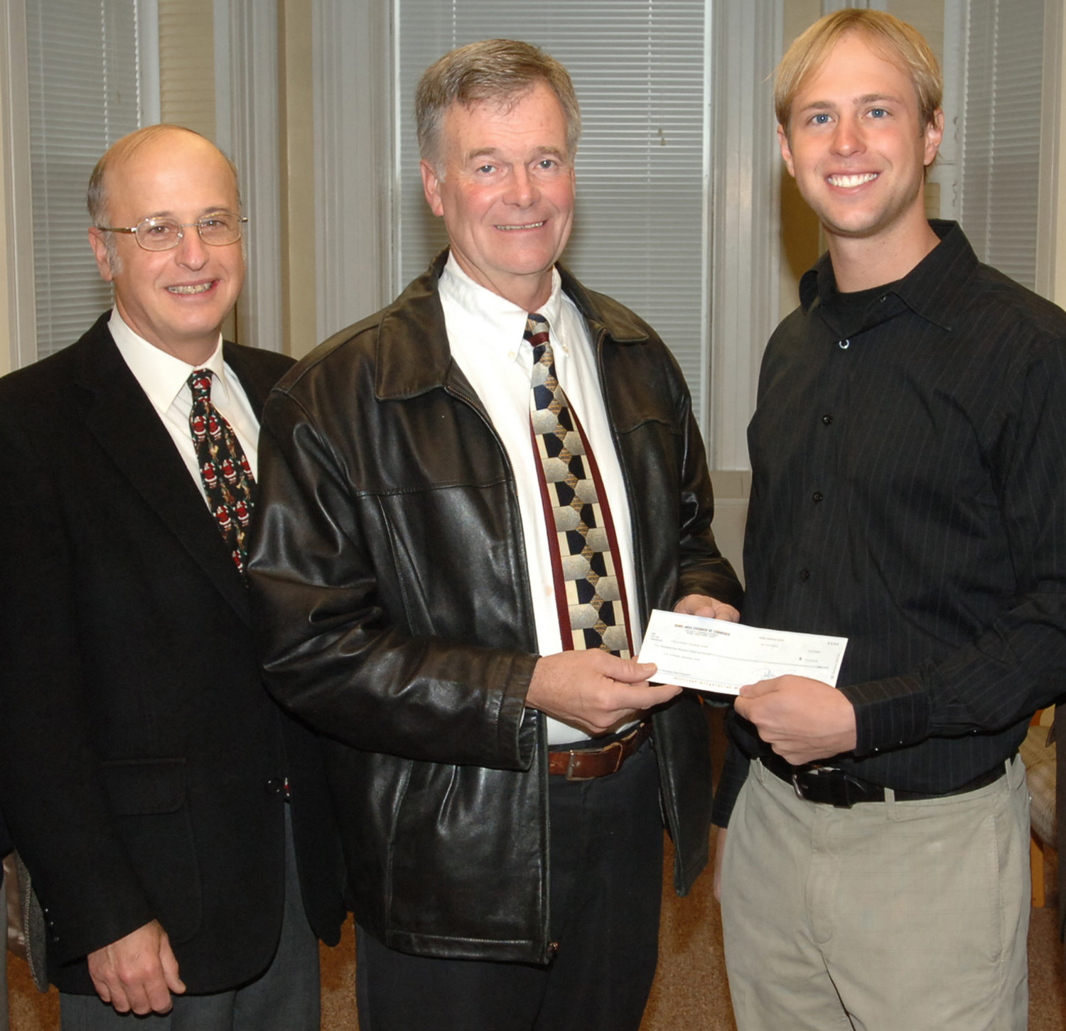 Showing his support for a renovation project of the city’s J.F. Kennedy Civic Arena, Bill Guglielmo, left, is shown donating the proceeds — $5,115 — to the city’s Think Rink fund. From left: Guglielmo, former City Recreation Director Bill Fleet; and local businessman Wesley Cupp.