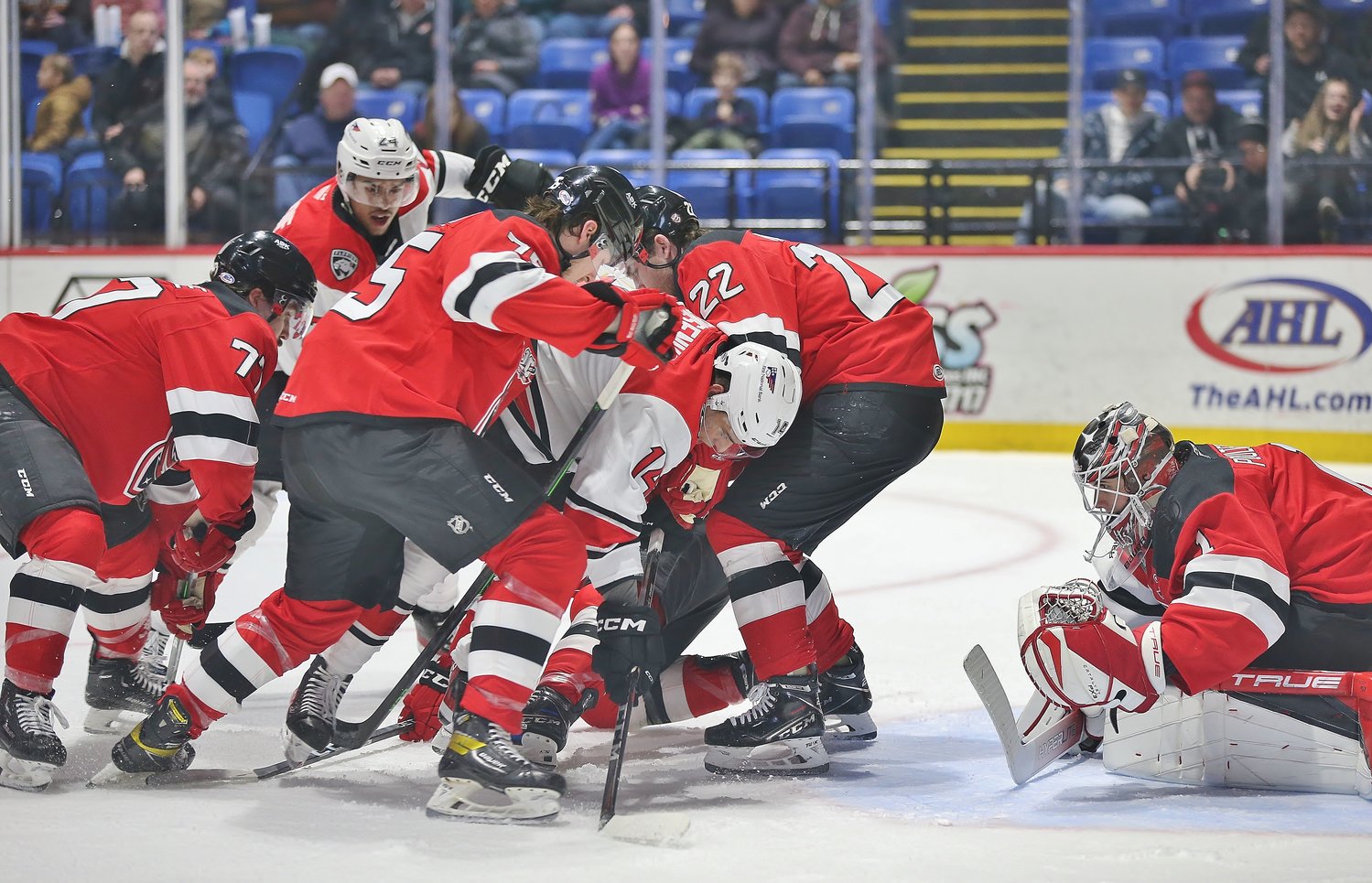 Isaac Poulter looks through a scrum in front of the net on Friday against the Charlotte Checkers at the Adirondack Bank Center. Poulter made 28 saves in a solid performance, though Charlotte won 2-1.