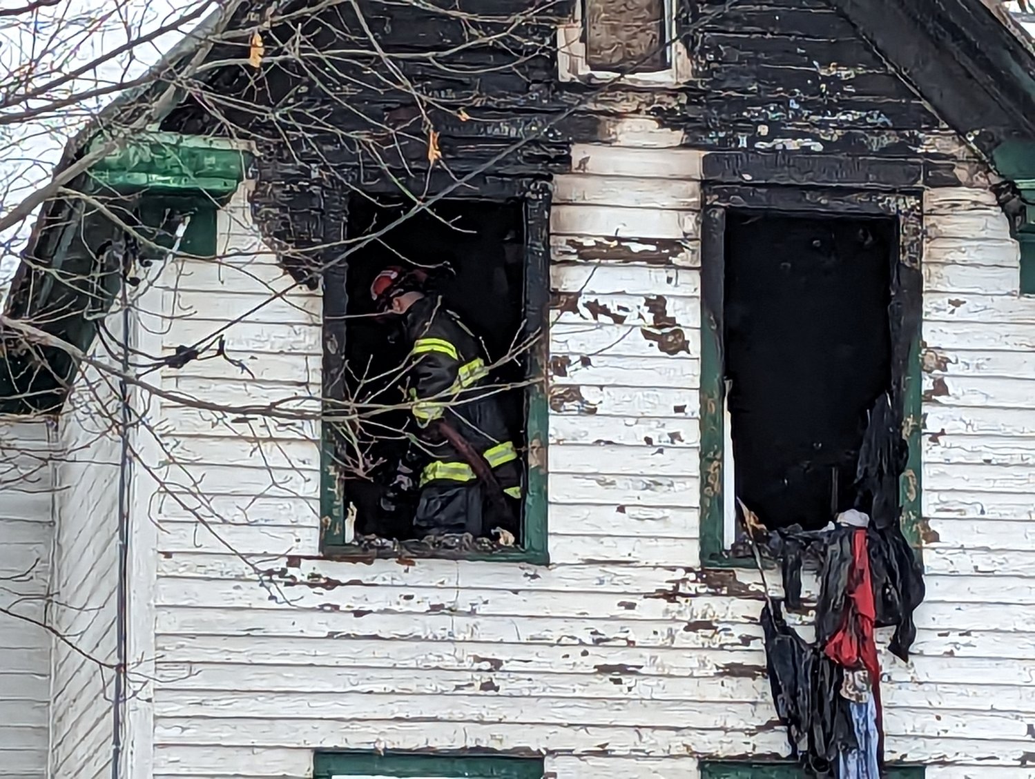 A Rome firefighter douses hot spots on the second floor of 206 S. Doxtator Ave. in Rome on Saturday. Fire officials said two upstairs bedrooms were heavily damaged by the fire. The cause remains under investigation.