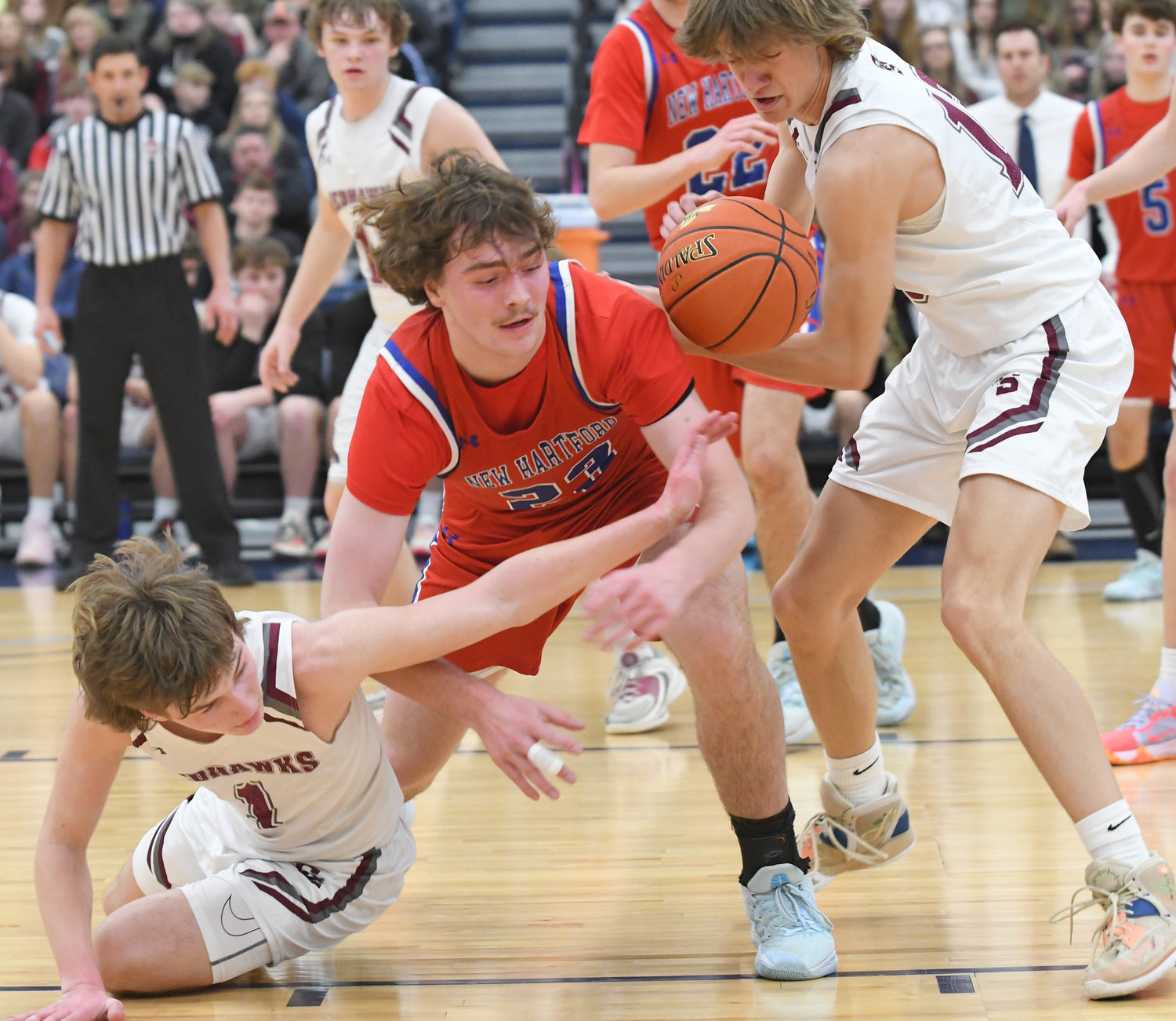 Central Square's Colin Kees and Tyler Meigel tie up New Hartford's Zach Philipkoski in the first half at SRC Arena in Syracuse. Philipkoski had 24 points in New Hartford's 65-60 win.