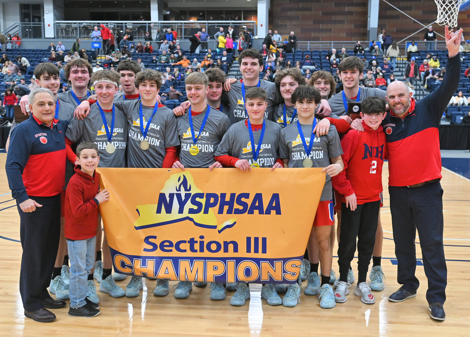 New Hartford boys basketball team celebrates their Section III championship  after defeating Central Square Sunday night at SRC Arena in Syracuse.