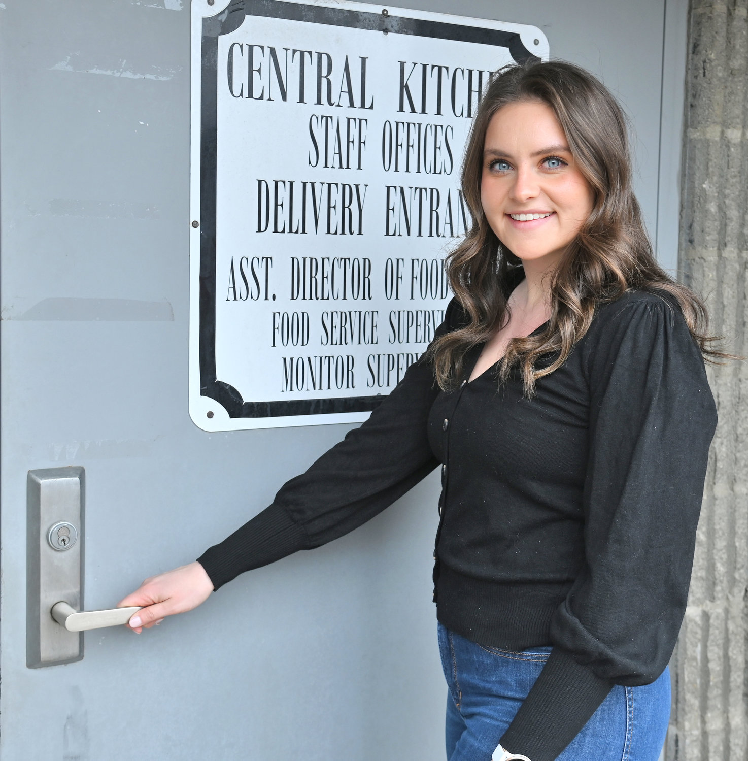 OHM BOCES and Utica City School District Registered Dietitian Nutritionist Hayley Mielnicki poses Friday, March 3 at the entrance of the Central Kitchen on Elizabeth Street in Utica.