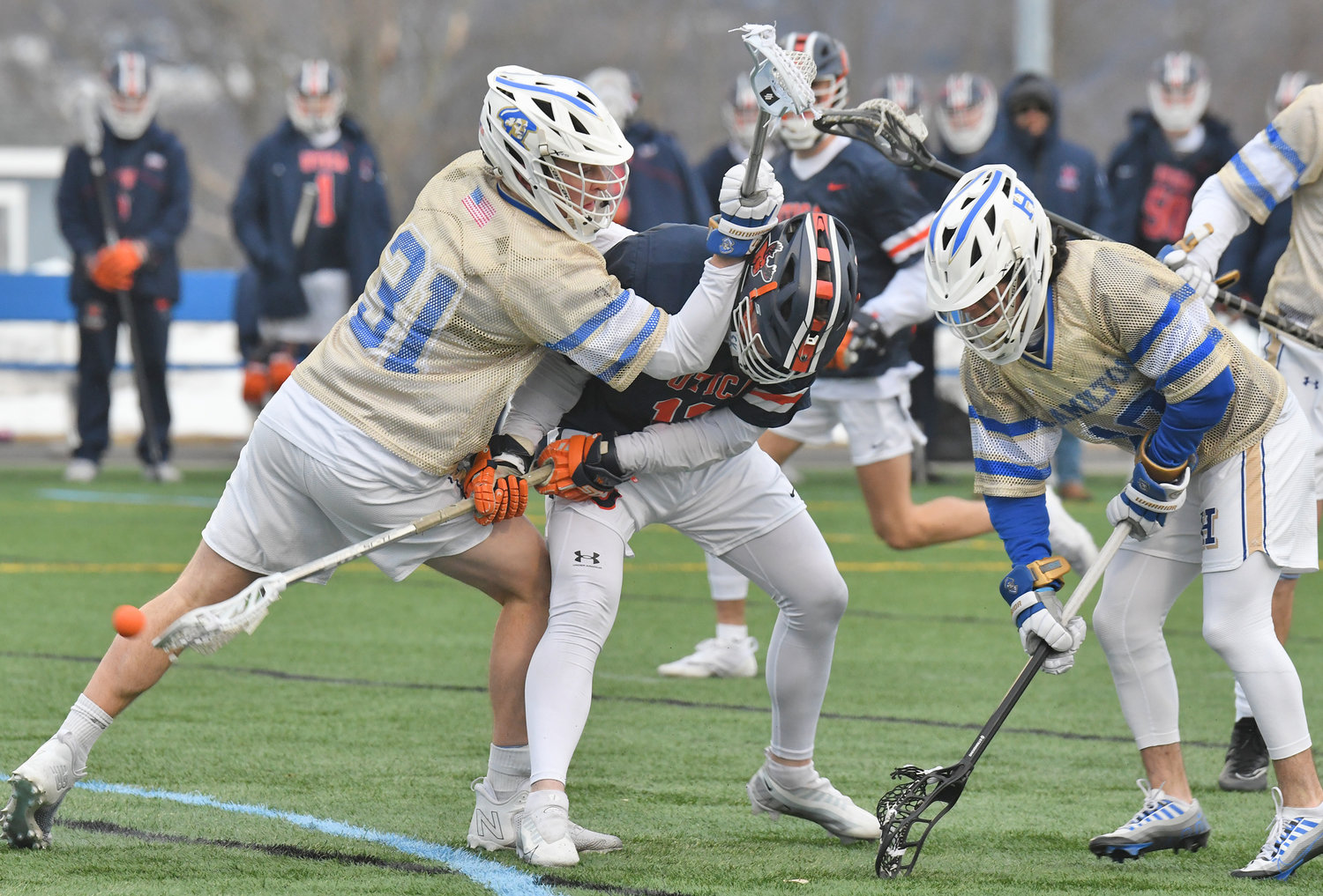 DOUBLE-TEAMED — Hamilton College’s Kyle Mannherz, left, and teammate Zach Lucchini, right, smother Utica University’s Sam Serrano as he tries to get a shot on goal in the first quarter of Tuesday’s men's lacrosse game at Hamilton College’s Withiam Field in Clinton. Serrano scored a pair of goals, but Hamilton rolled to a 20-5 win in the 23rd playing of the Contineer Cup.