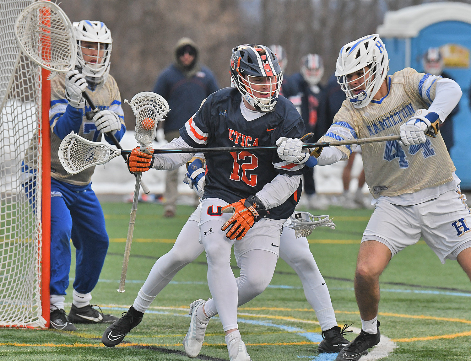 TRIPLE-TEAMED — Utica Univeristy's Sam Serrano is defended by Hamilton College's Dominic Mauretti, right, and Cole Johnson (behind) with Seamus Fagan in goal on Tuesday at Hamilton College's Withiam Field in Clinton. Serrano scored a pair of goals, but Hamilton rolled to a 20-5 win in the 23rd playing of the Contineer Cup.