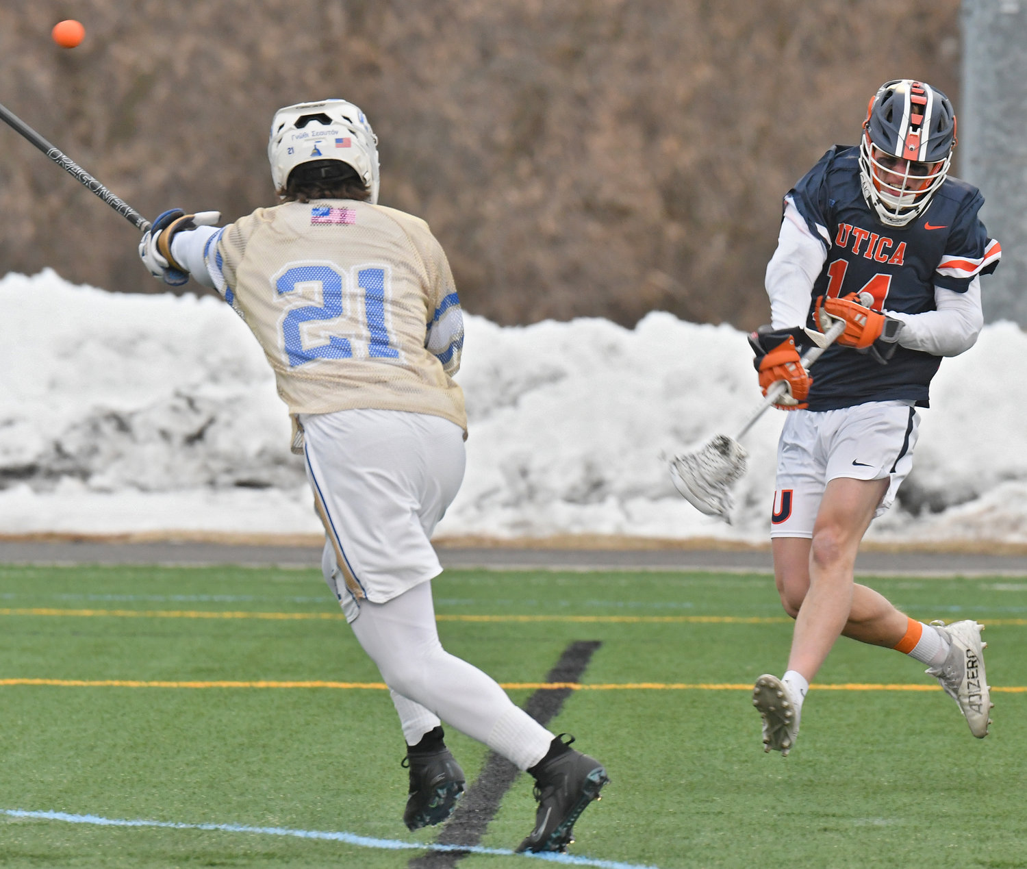 SHOT ATTEMPT — Utica University's Luke Rinaudo-Concessi whips a shot on goal with Hamilton College's Cole Johnson defends during Tuesday's men's lacrosse game at Hamilton College's Withiam Field in Clinton.