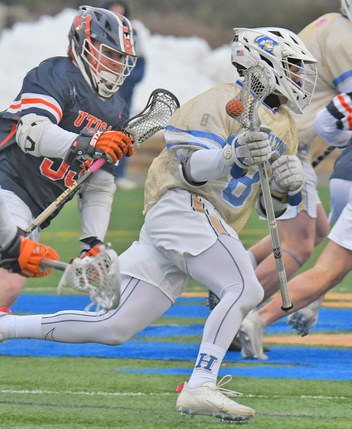 ON THE RUN — Hamilton College's Michael Scoleri runs up field as Utica University's Jack Hogan defends during Tuesday's men's lacrosse game at Hamilton College's Withiam Field in Clinton.