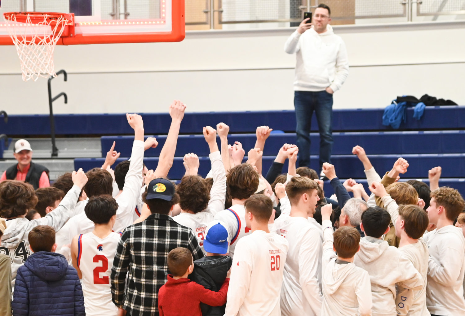 New Hartford players and fans celebrate following the team's Class A regional win on Wednesday at Liverpool High School. Fans from New Hartford wore white to show support during the game.