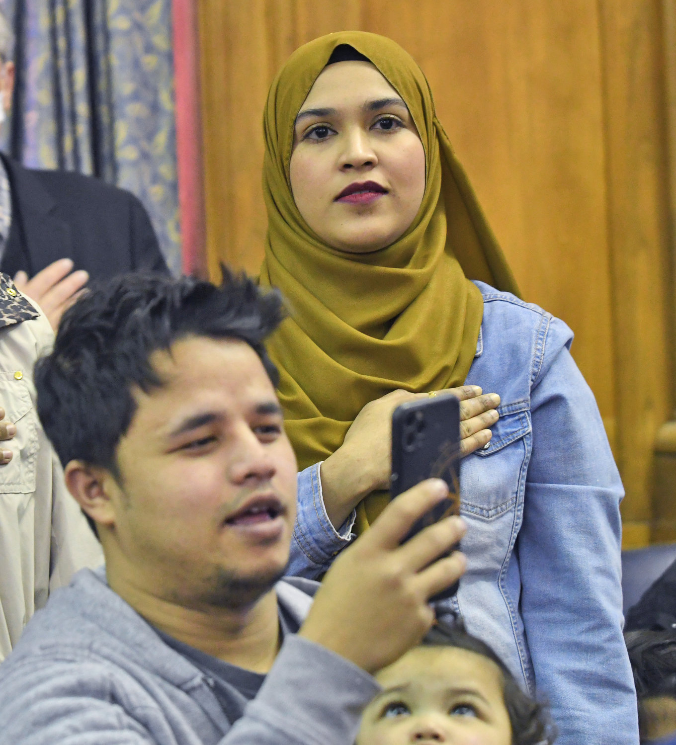 New citizen Siti Fatimah Binti Abdul Salam formerly of Malaysia recites the Pledge of Allegiance on Thursday during a naturalization ceremony at the Alexander Pirnie Federal Courthouse in Utica which welcomed 50 new American citizens.