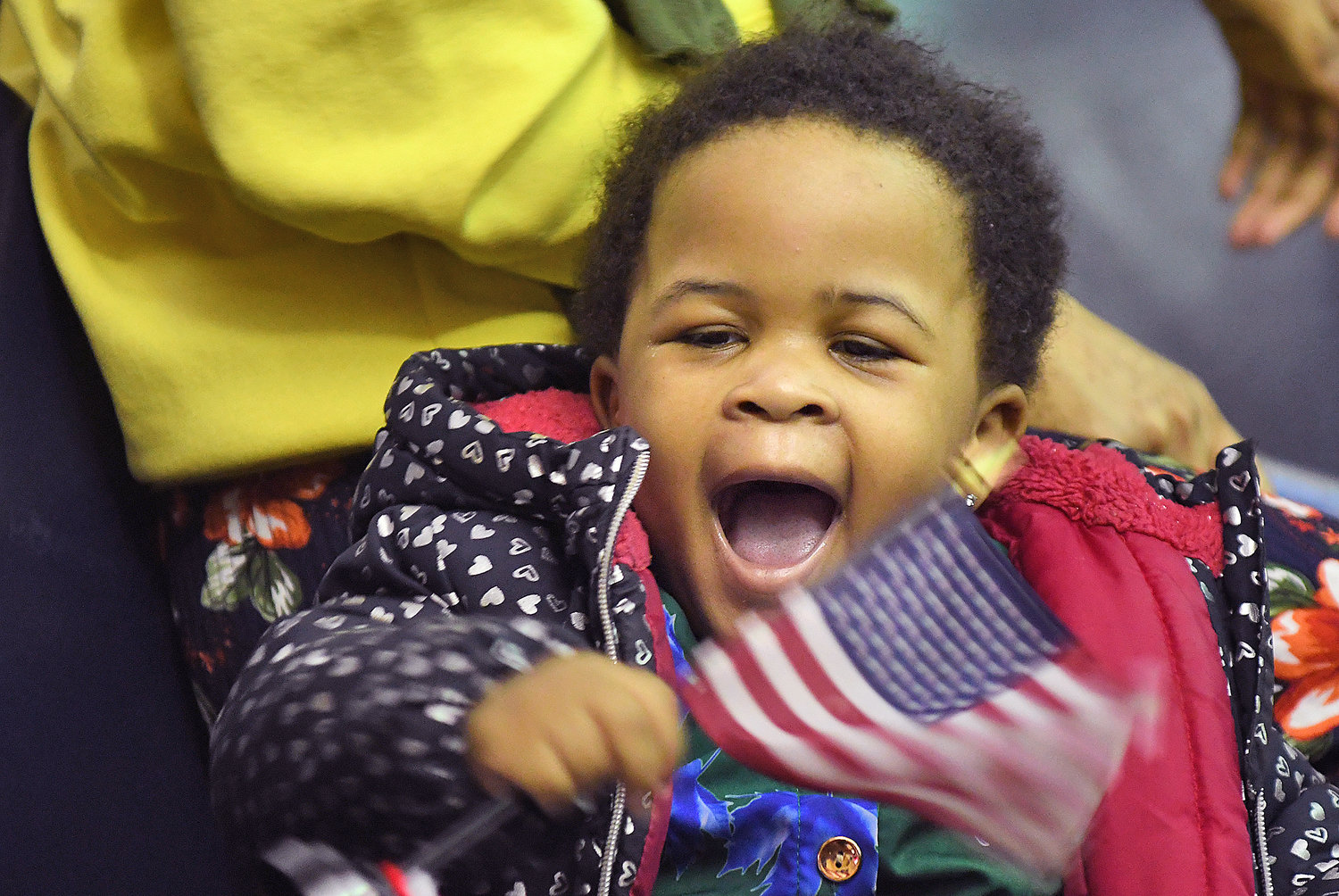 Sagal Abdirahim, 2, waves an American flag after her uncle was naturalized Thursday, March 9 in a ceremony at the Alexander Pirnie Federal Courthouse in Utica.