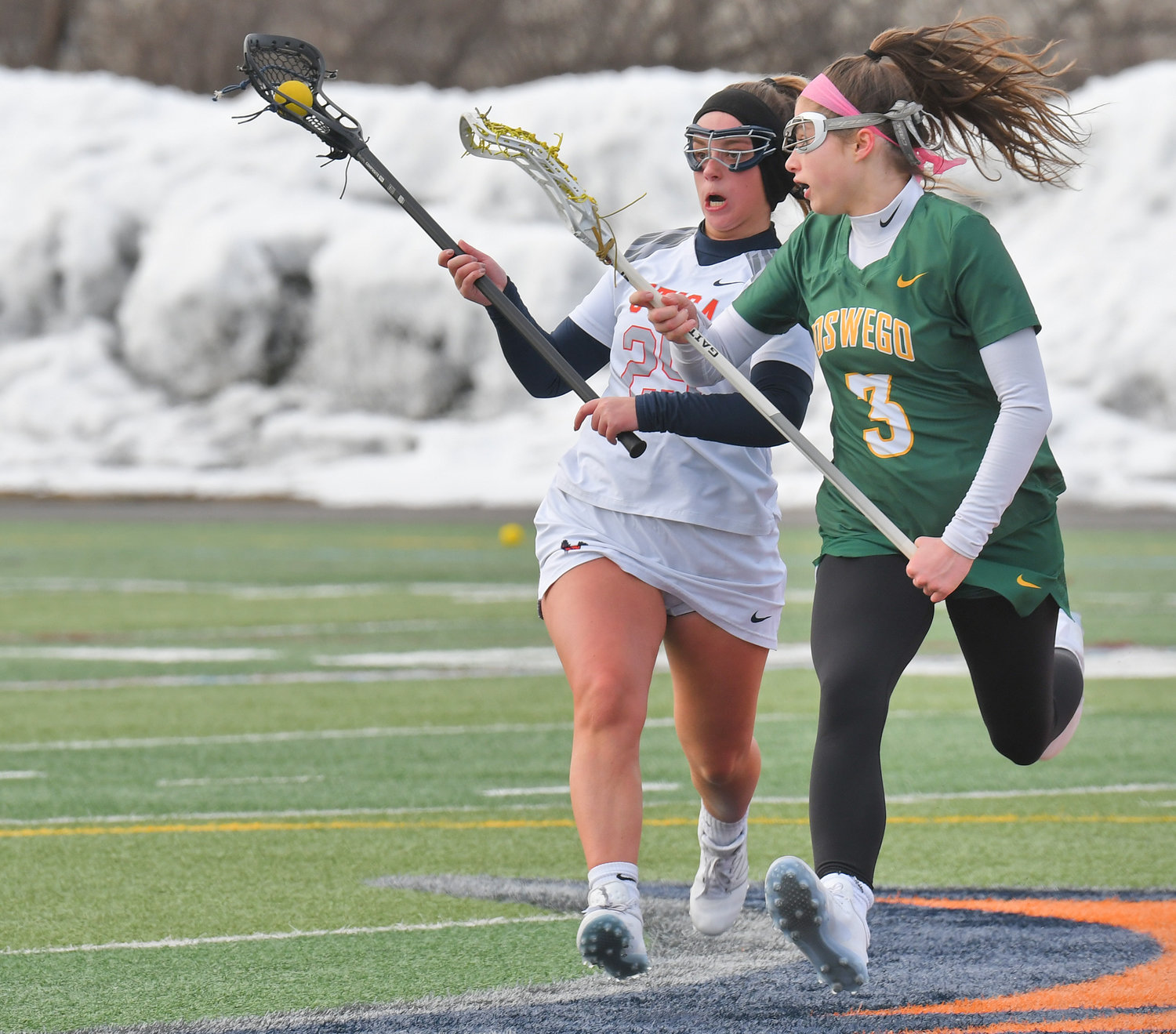 CLOSELY DEFENDED — Utica University’s Alyssa Drell drives as SUNY Oswego’s Noelle Smith defends in the first quarter of Wednesday’s non-league women’s lacrosse game at Gaetano Stadium in Utica. Drell scored a pair of goals, but SUNY Oswego won 6-5. Both teams are 2-1 on the season.