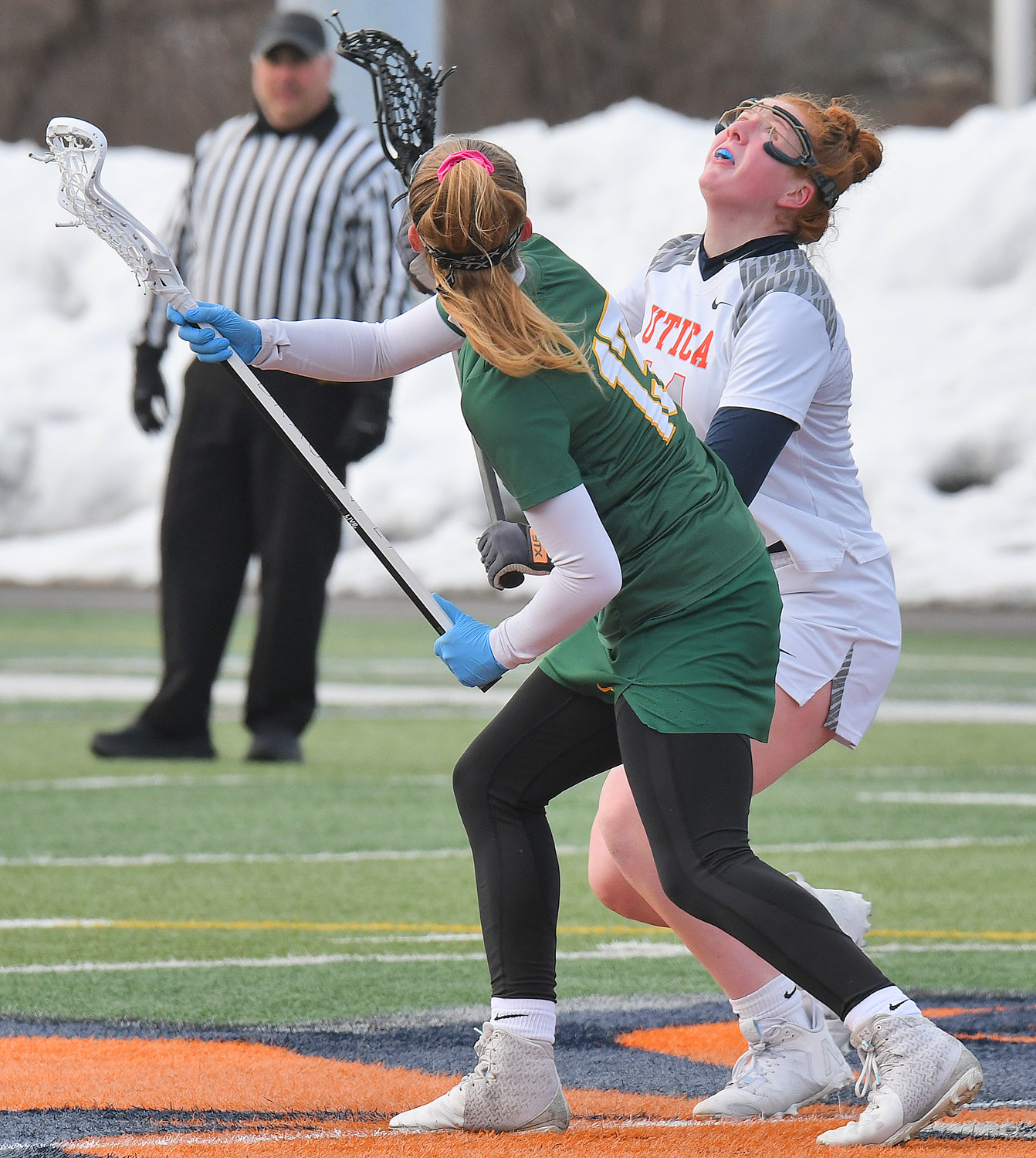 IN THE AIR — Utica University's Grace Stuhlman, of Whitesboro, and SUNY Oswego's Julia Quirk watch the ball in the air after facing off in the first quarter during Wednesday's non-league women's lacrosse game at Gaetano Stadium in Utica.