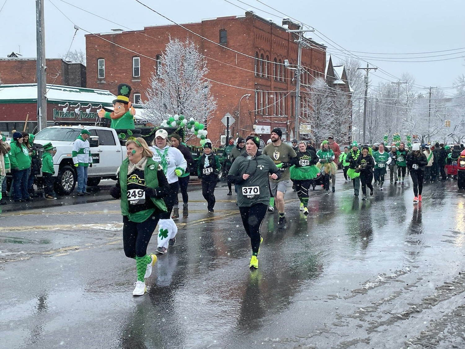 These runners are all smiles and in all green as they make their way down Genesee Street just before the start of the Utica St. Patrick's Day Parade on Saturday, March 11, 2023.