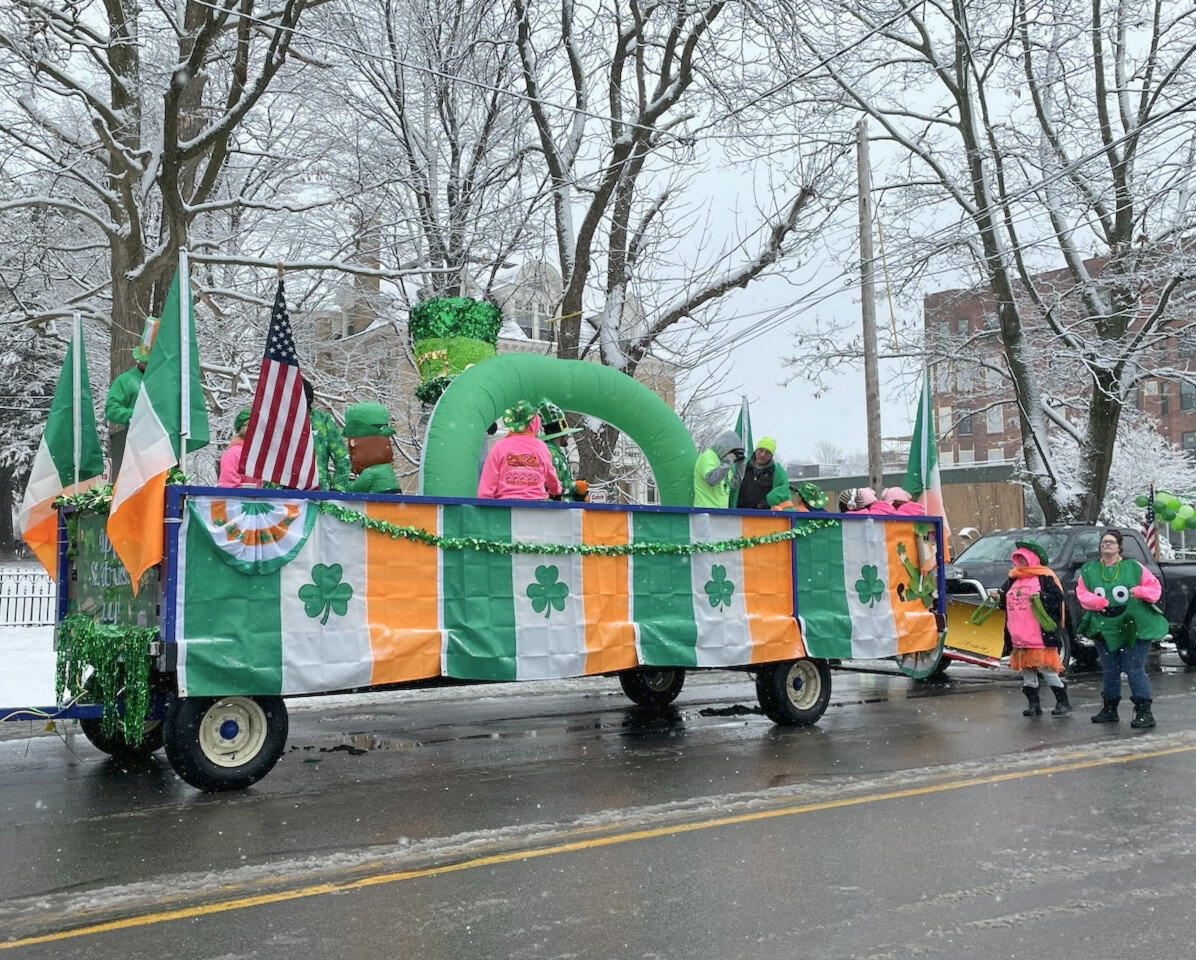 A float adorned in Irish pride makes its way down Genesee Street during Utica's St. Patrick's Day Parade Saturday.