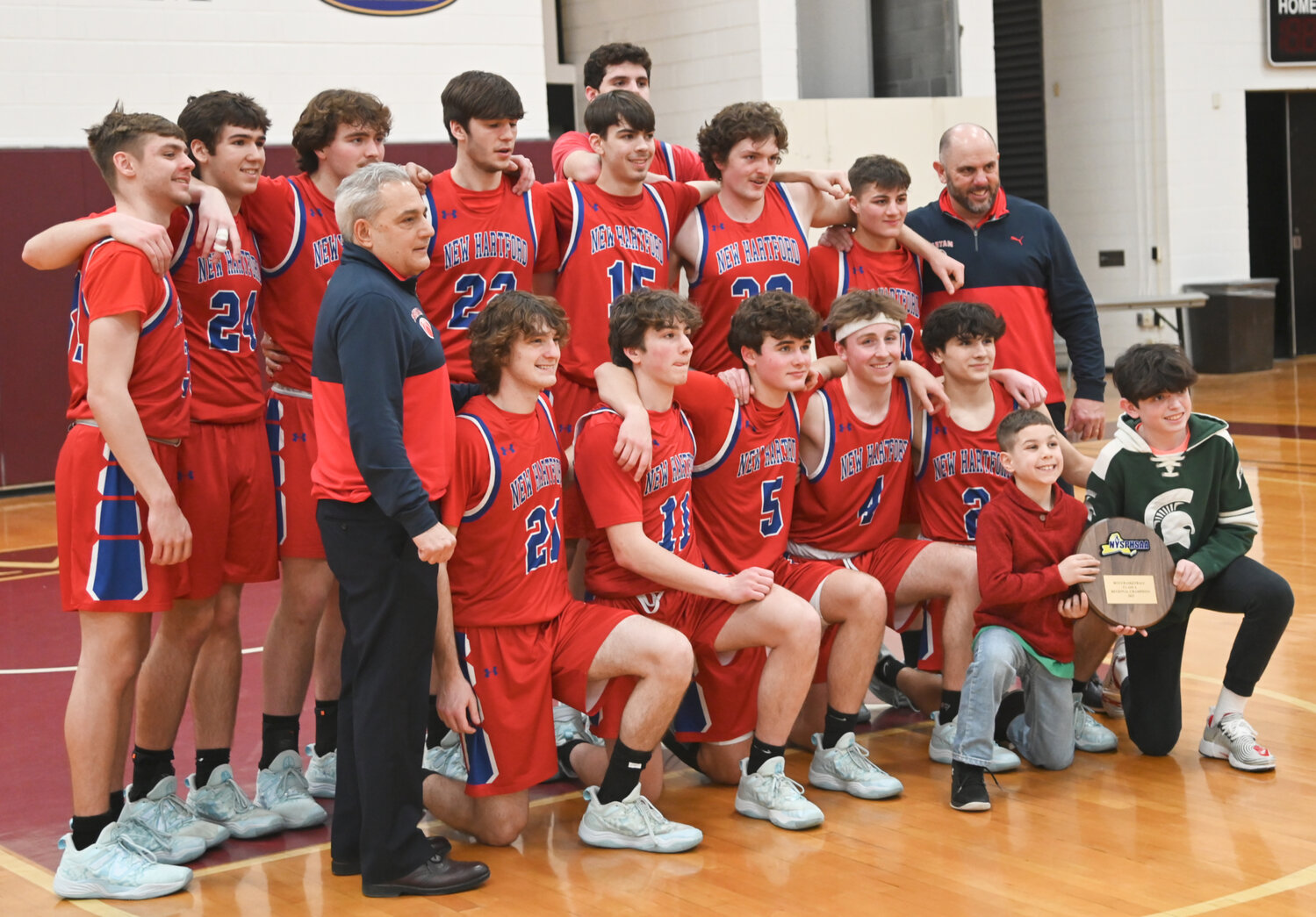 The New Hartford boys basketball team celebrates after claiming the Class A regional final title on Saturday at SUNY Potsdam.