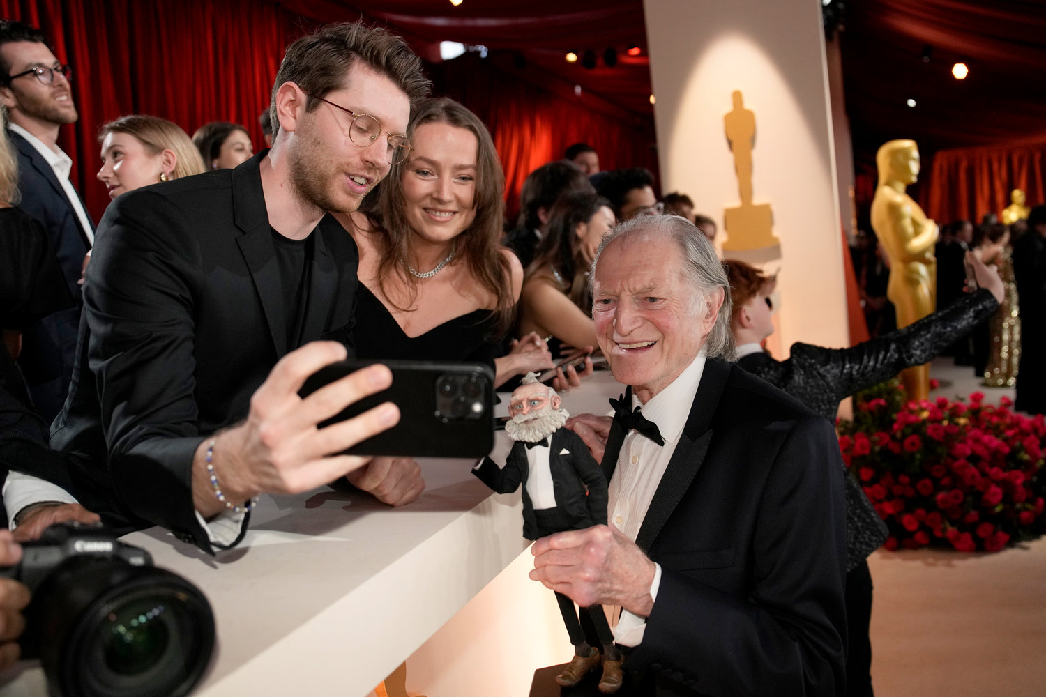 David Bradley poses for a selfie with fans at the Oscars on Sunday, March 12, 2023, at the Dolby Theatre in Los Angeles. (AP Photo/John Locher)