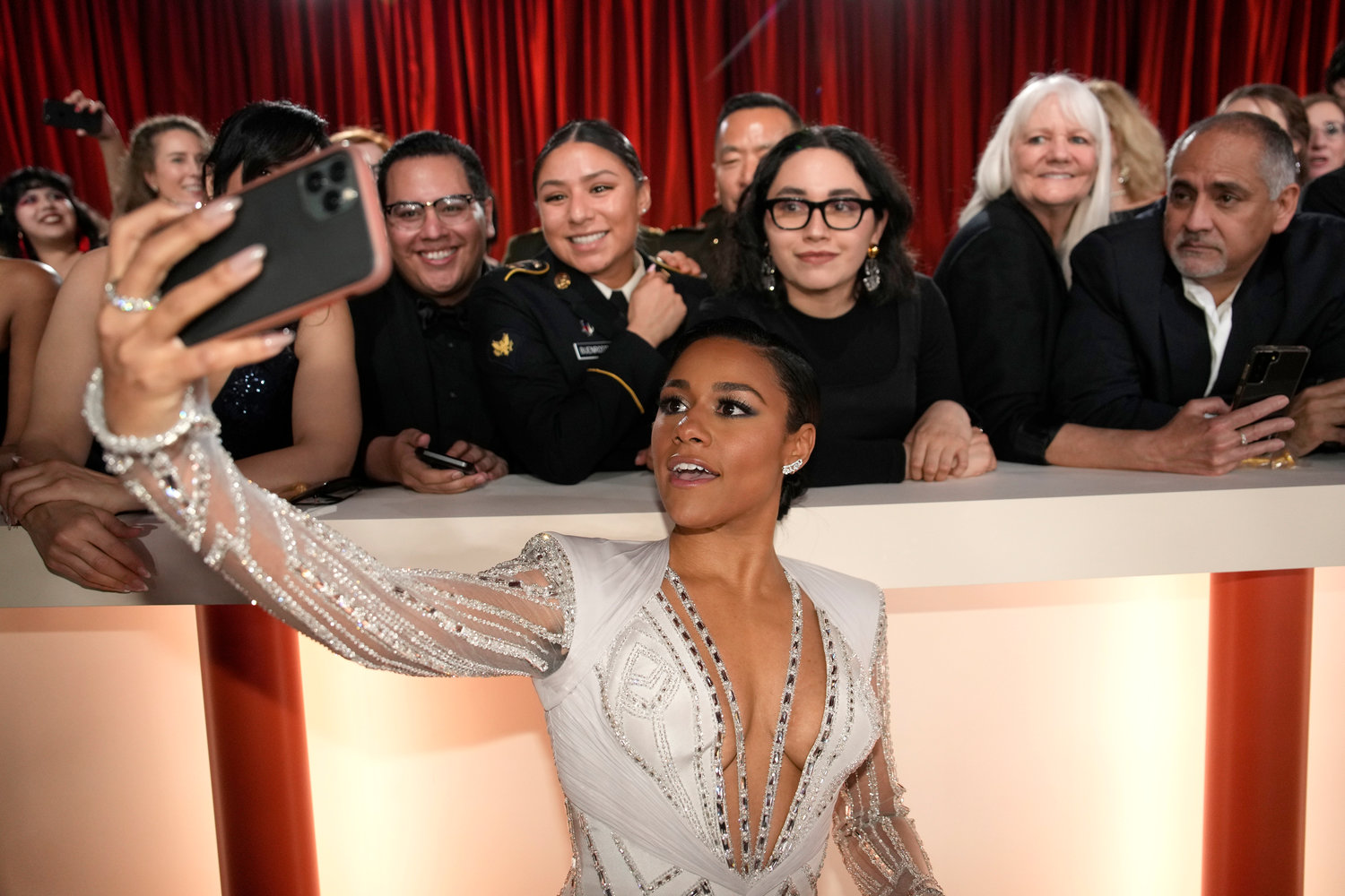Ariana DeBose takes a selfie with fans on carpet at the Oscars on Sunday, March 12, 2023, at the Dolby Theatre in Los Angeles. (AP Photo/John Locher)