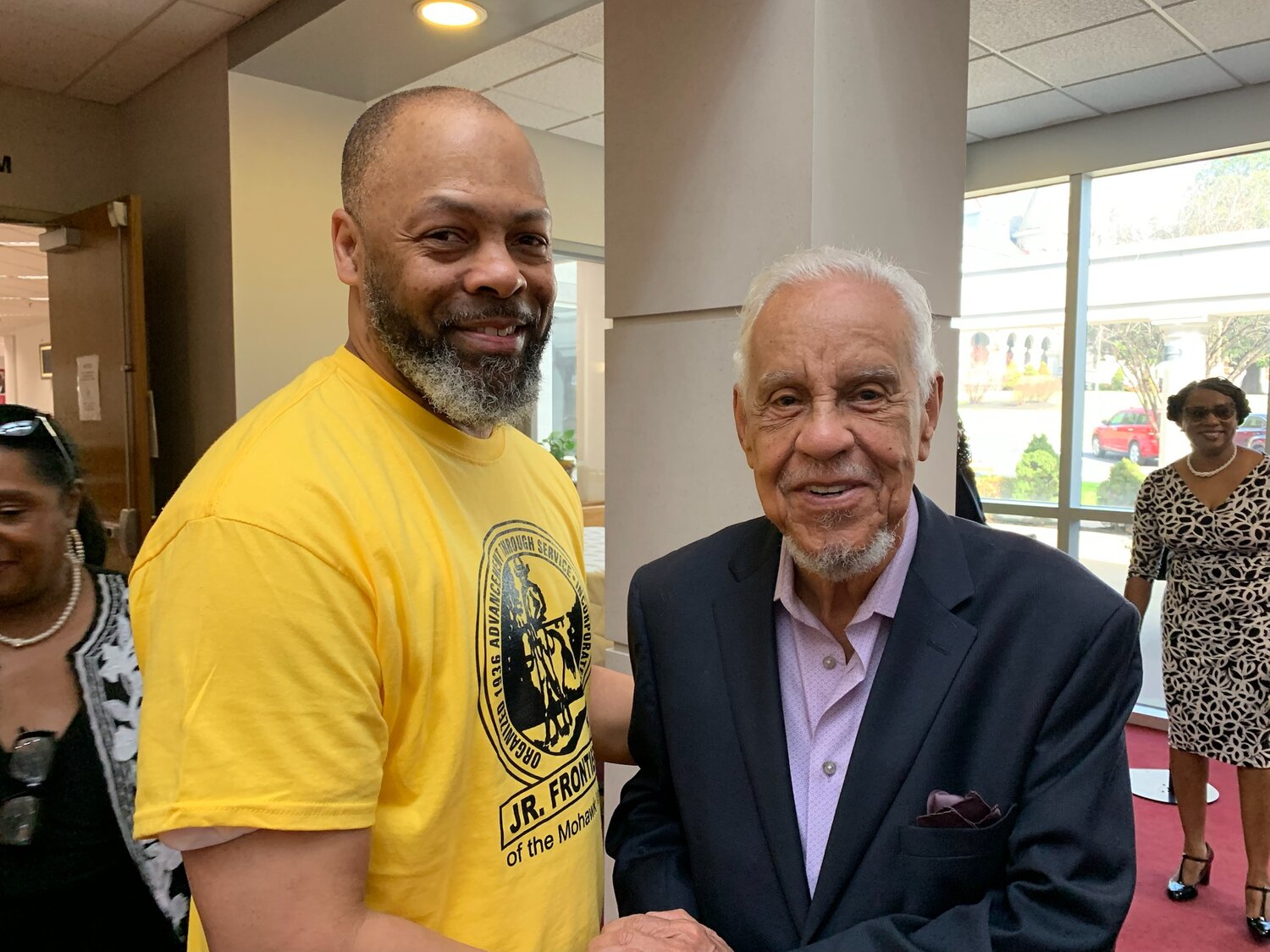 From left, James Paul III —  the Utica School Board Director, and co-director  of Jr. Frontiers — is all smiles as he greets Douglas Wilder the first African American elected to Governor of Virginia at Virginia Union College.