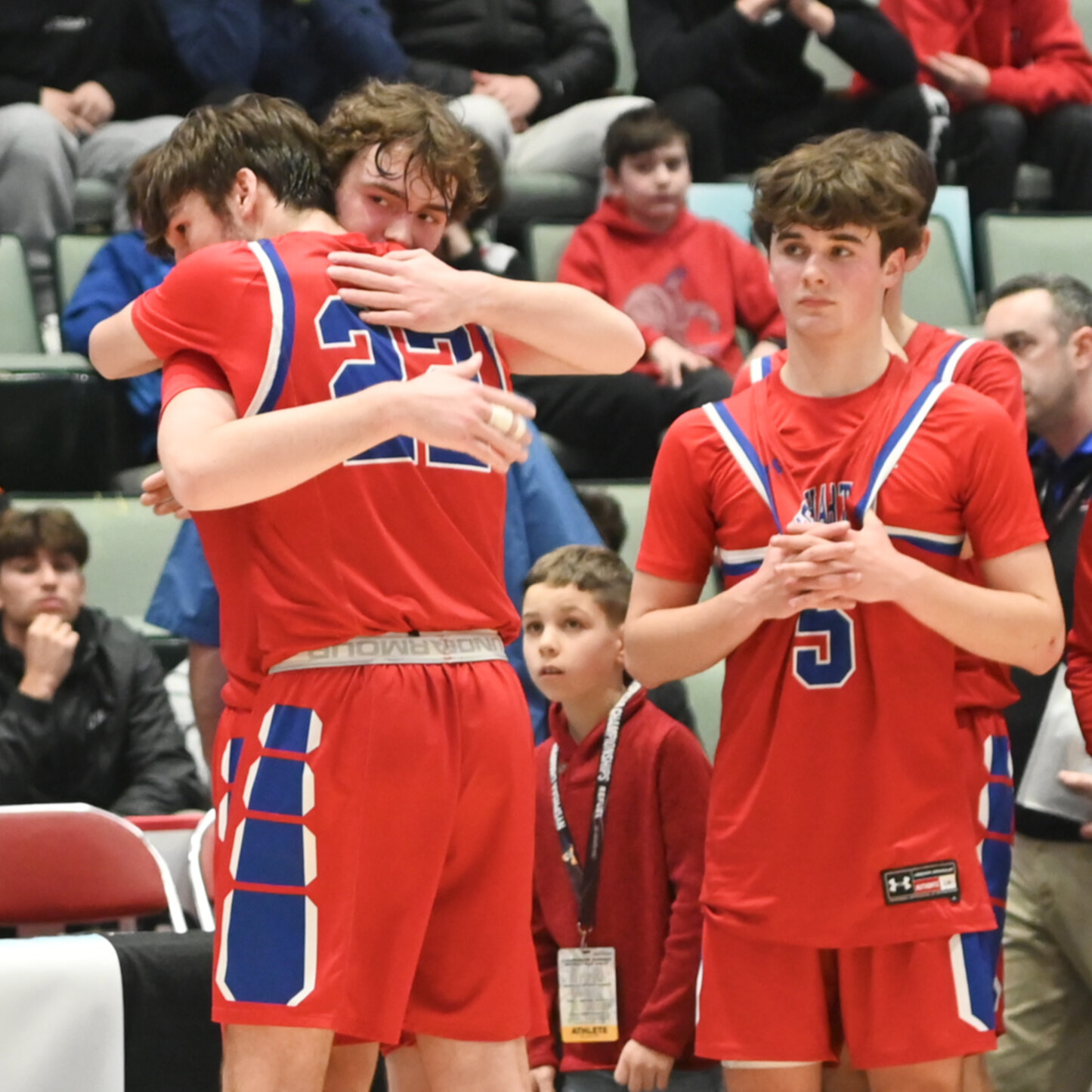 Senior Zach Philipkoski hugs classmate Colton Suriano following New Hartford's 58-48 setback to  Tappan Zee in the state Class A semifinal on Friday at Cool Insuring Arena in Glens Falls.
