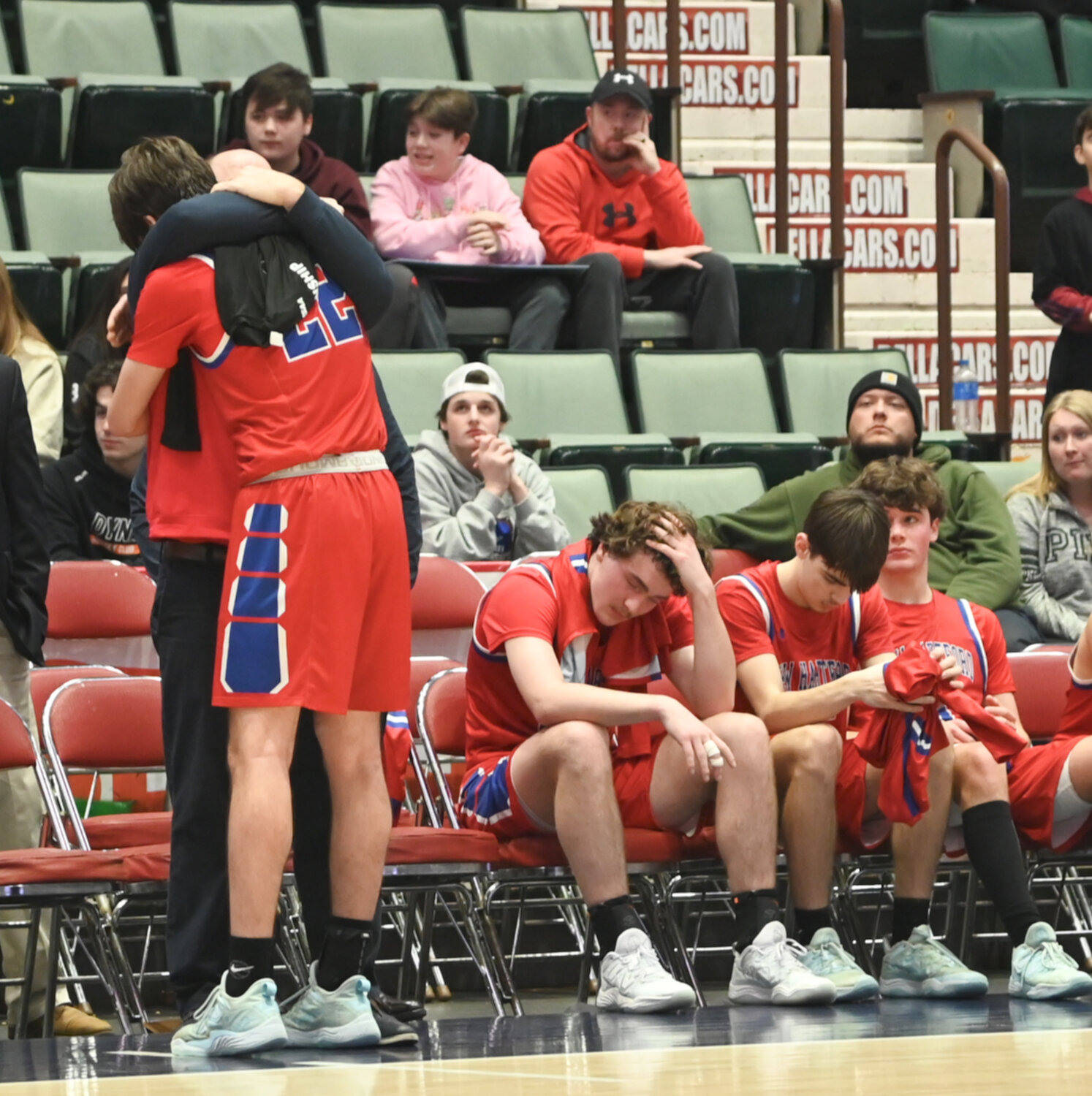 New Hartford coach John Randall hugs senior Colton Suriano after the team's 58-48 setback to Tappan Zee in the state Class A semifinal game at Cool Insuring Arena in Glens Falls.