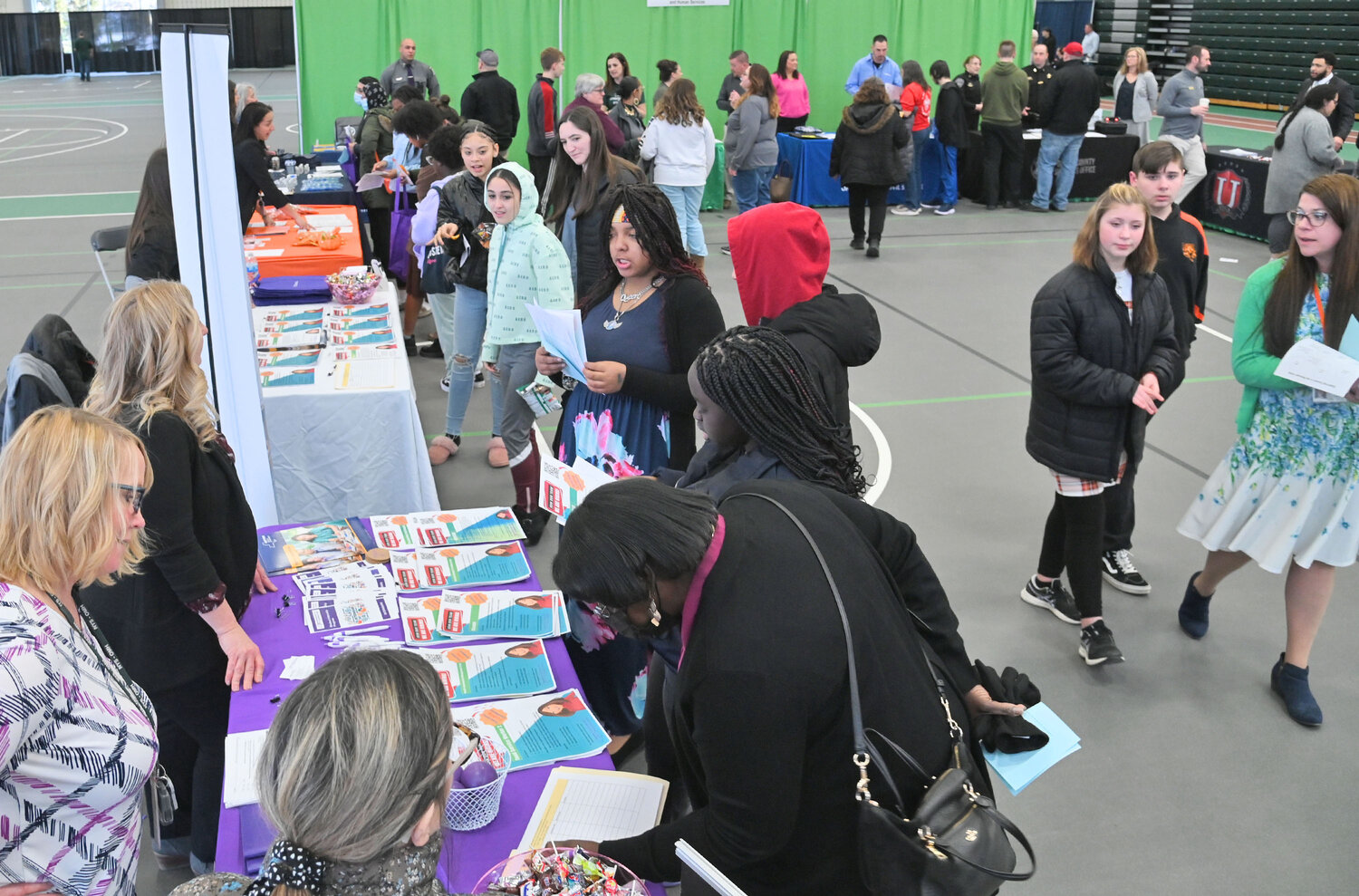 A very busy jobs fair is seen from over the top of the New York State Central New York Psychiatric Center information table Tuesday, March 21 during the Exploring Careers in the Mohawk Valley event, held at Mohawk Valley Community College in Utica.