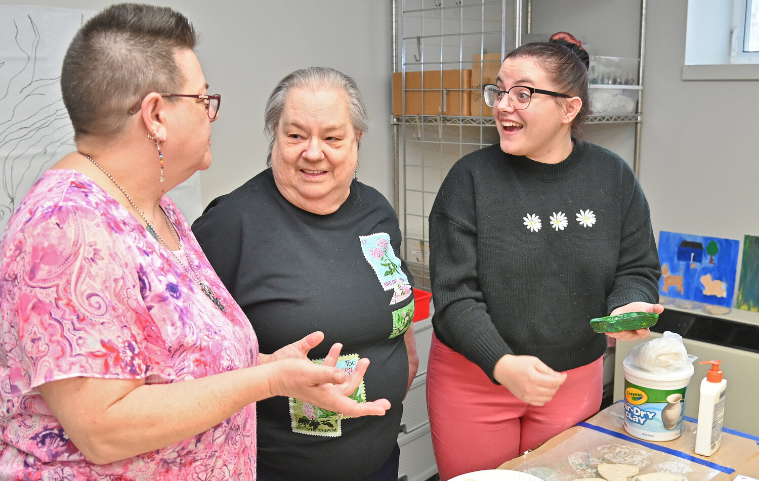 From left, Ida Weiss, daughter of participant Mary Youker with Celena Moulton, art therapy intern at the Resource Center for Independent Living’s Open House on Wednesday, March 22. They were looking over a community art project that participant Youker was working on.