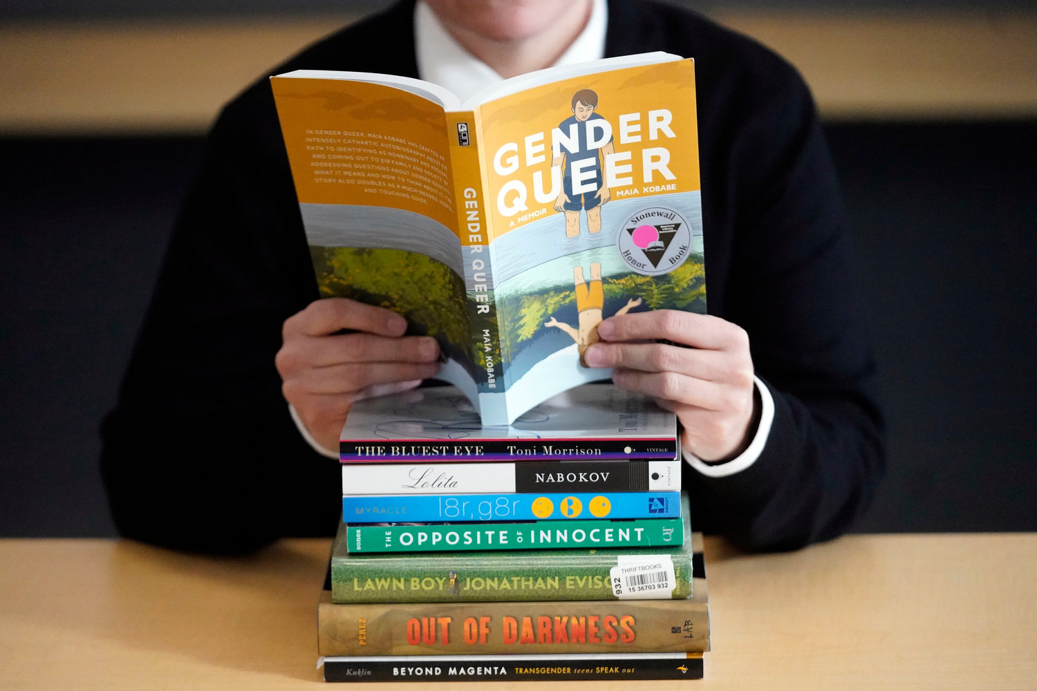 A pile of challenged books appear at the Utah Pride Center in Salt Lake City on Dec. 16, 2021. Attempted book bannings and restrictions at school and public libraries continue to surge, according to a new report from the American Library Association.