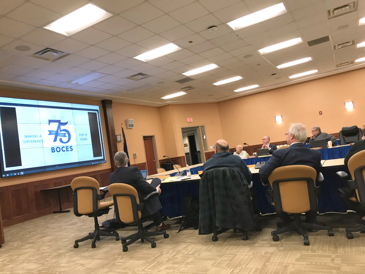 Members of the Cooperative Board of Oneida-Herkimer-Madison BOCES watch a video celebrating OHM BOCES' 75th anniversary during their January monthly meeting.