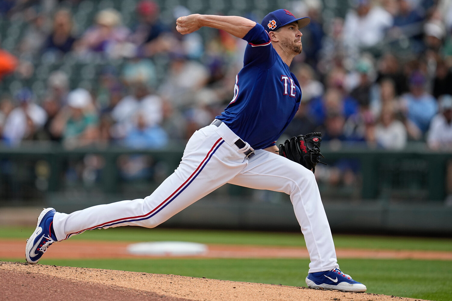 Texas Rangers starting pitcher Jacob deGrom delivers a pitch against the Seattle Mariners, on Sunday in Surprise, Ariz. The ace-righthander, who signed a five-year, $185 million contract with the Rangers in the offseason, will face Philadelphia’s Aaron Nola when the 2023 Major League Baseball season opens on Thursday.