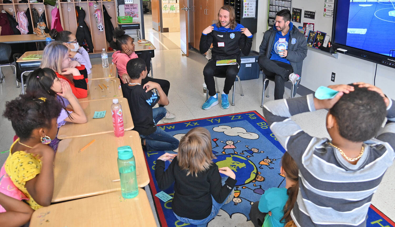 ‘SIMON SAYS’ — Utica City FC player Timmy Goldman plays “Simon Says” with the third grade class of Jordan Penc before reading the book “Game Time” during the inaugural Community Reader’s Day event on Friday morning at Kernan Elementary School in Utica. Helping him is teammate Rafa Godoi.