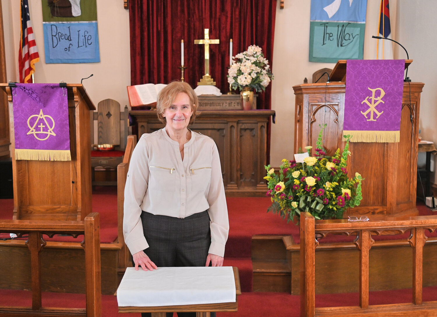 The Rev. Karen Marshall, pastor, stands before the alter of Trinity Church in Rome, 215 W. Court St. The church will celebrate its 175th anniversary with a three-day celebration in April.