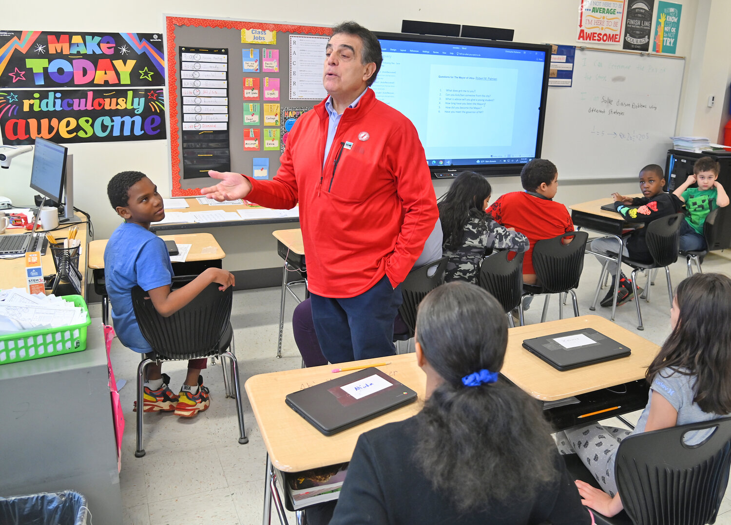 Utica Mayor Robert Palmieri talks with a class Friday, March 24 during the Community Reader's Day event at Kernan Elementary School in Utica.