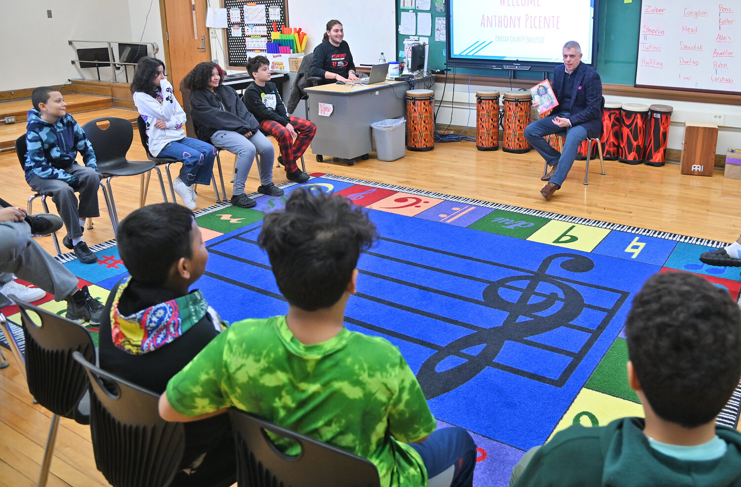 Oneida County Executive Anthony Picente reads "A Bad Case of Stripes" to a music class Friday, March 24 during Community Reader's Day at Kernan Elementary School in Utica.