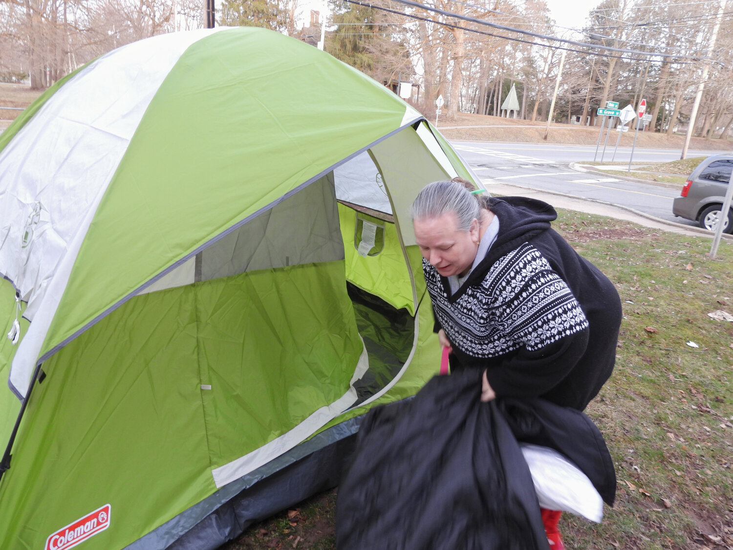 Karing Kitchen Coordinator Melissa King finishes setting up her tent and gathers up a few blankets for her homelessness awareness sleep-out