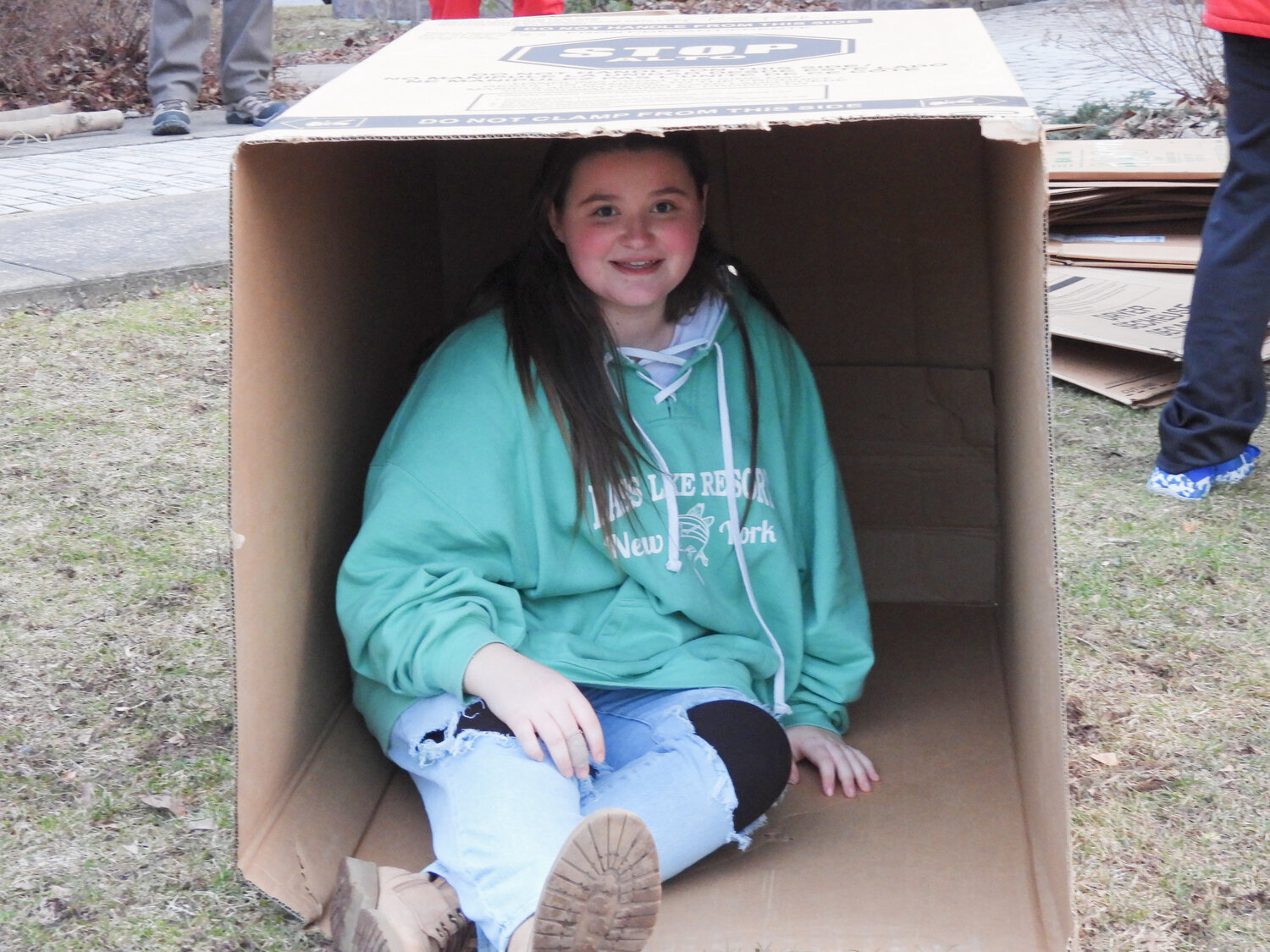 Oneida Scout Troop #2 sets up their cardboard shelters for the homelessness awareness sleep-out. Pictured is Courtney Clark, 12, a troop member and Oneida Middle Schoole.