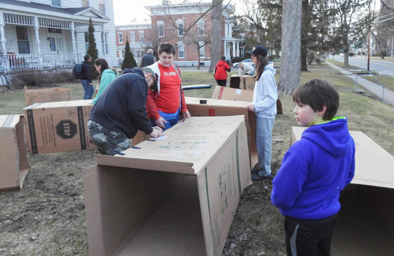 Oneida Scout Troop #2 sets up their cardboard shelters for the homelessness awareness sleep-out.
