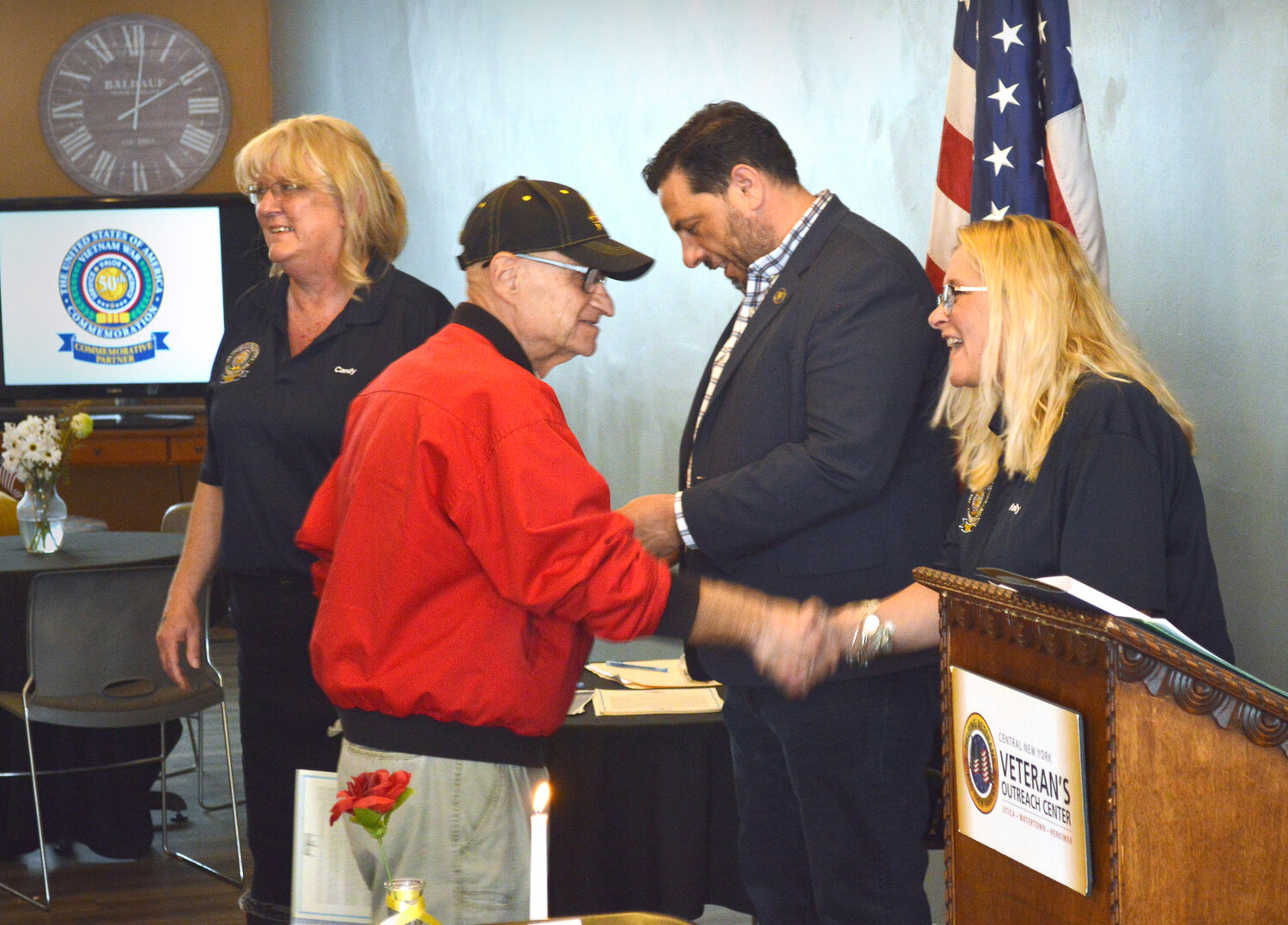 Vietnam veteran Nick LaBella, Utica, shakes hands with Kelly Walters, executive director 50 Forward Mohawk Valley after receiving his Commemoration Pin during the National Vietnam Veterans War Day, March 29, at the Central New York Veterans Outreach Center in Utica.