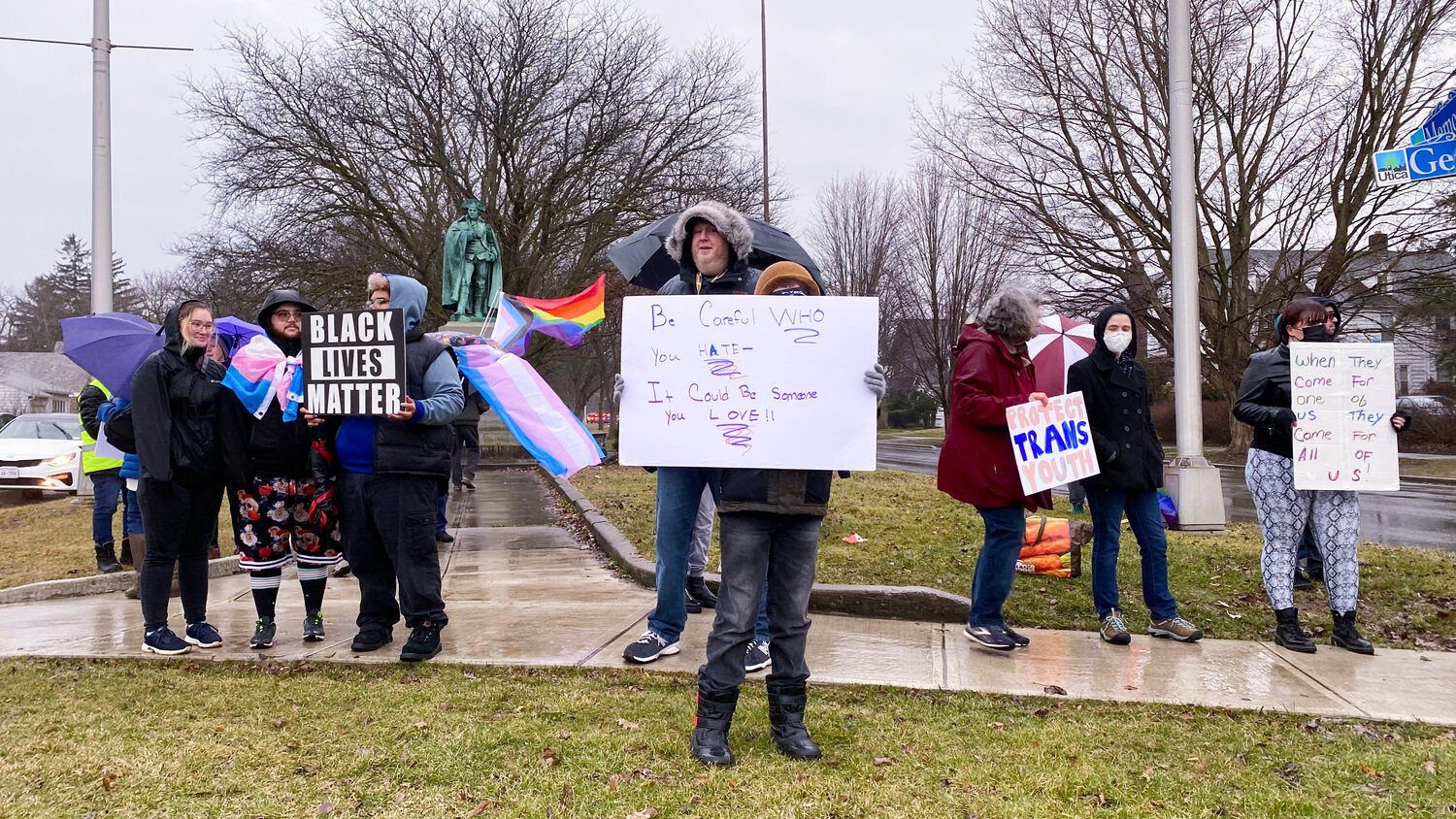 Signs of support for trans people and the LGBTQ+ community flooded the intersection of Genesee Street and Memorial Parkway in Utica on Friday, March 31 during the International Transgender Day of Visibility.