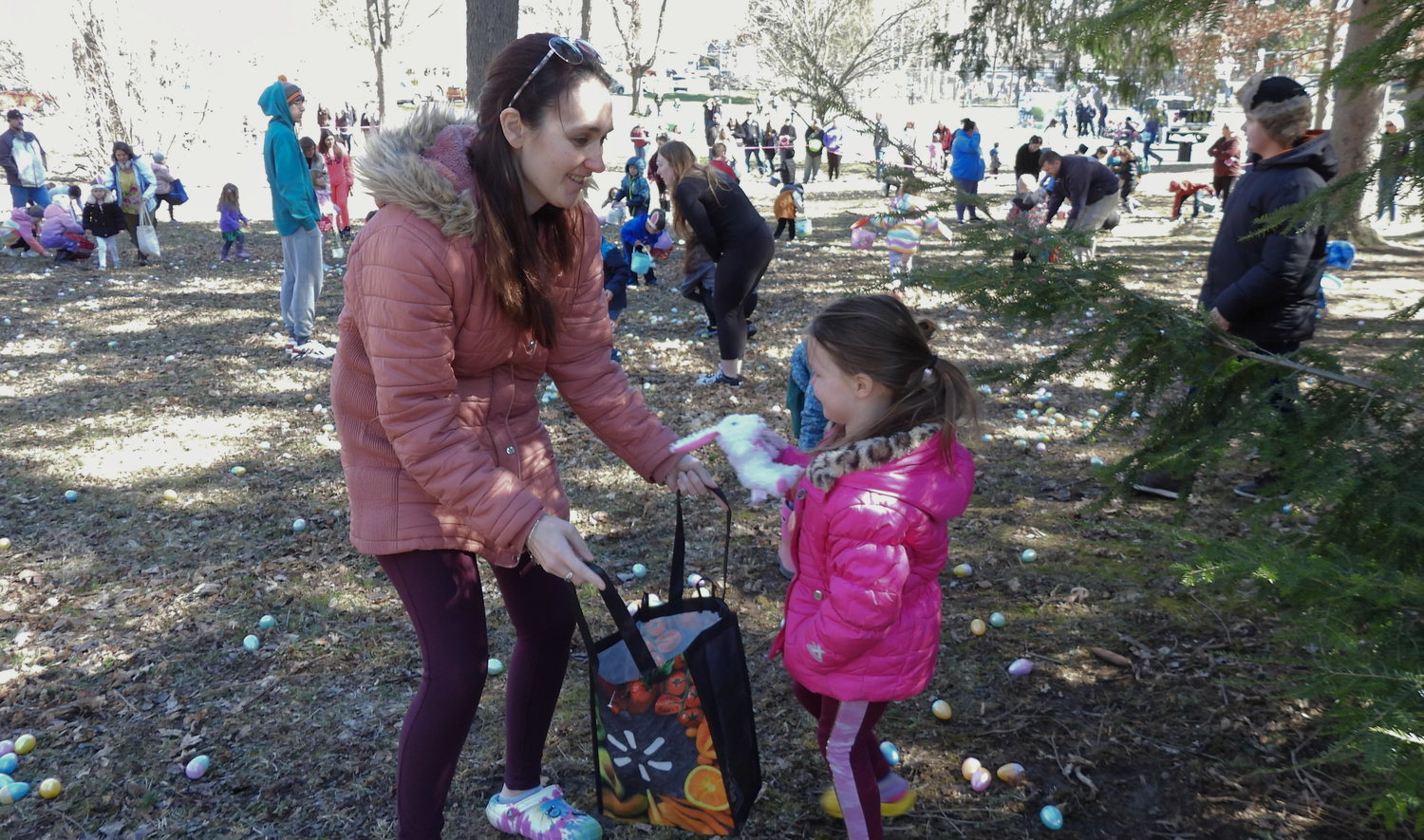 The annual Oneida Easter Egg Hunt saw kids of all ages in Allen Park filling their bags and baskets with eggs on Saturday, April 8 in Oneida. Pictured is Cindy Wilson, helping her five-year-old daughter Kairi collect one of the stuffed animals hidden in the park.