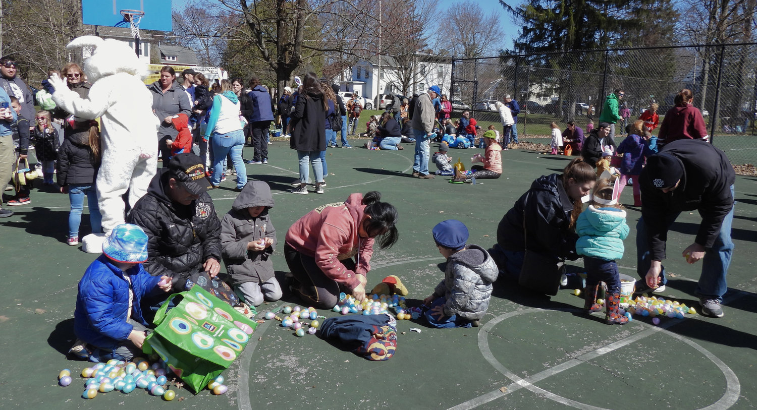 The annual Oneida Easter Egg Hunt saw kids of all ages in Allen Park filling their bags and baskets with eggs on Saturday, April 8 in Oneida. Pictured are parents helping their children open eggs after the hunt.