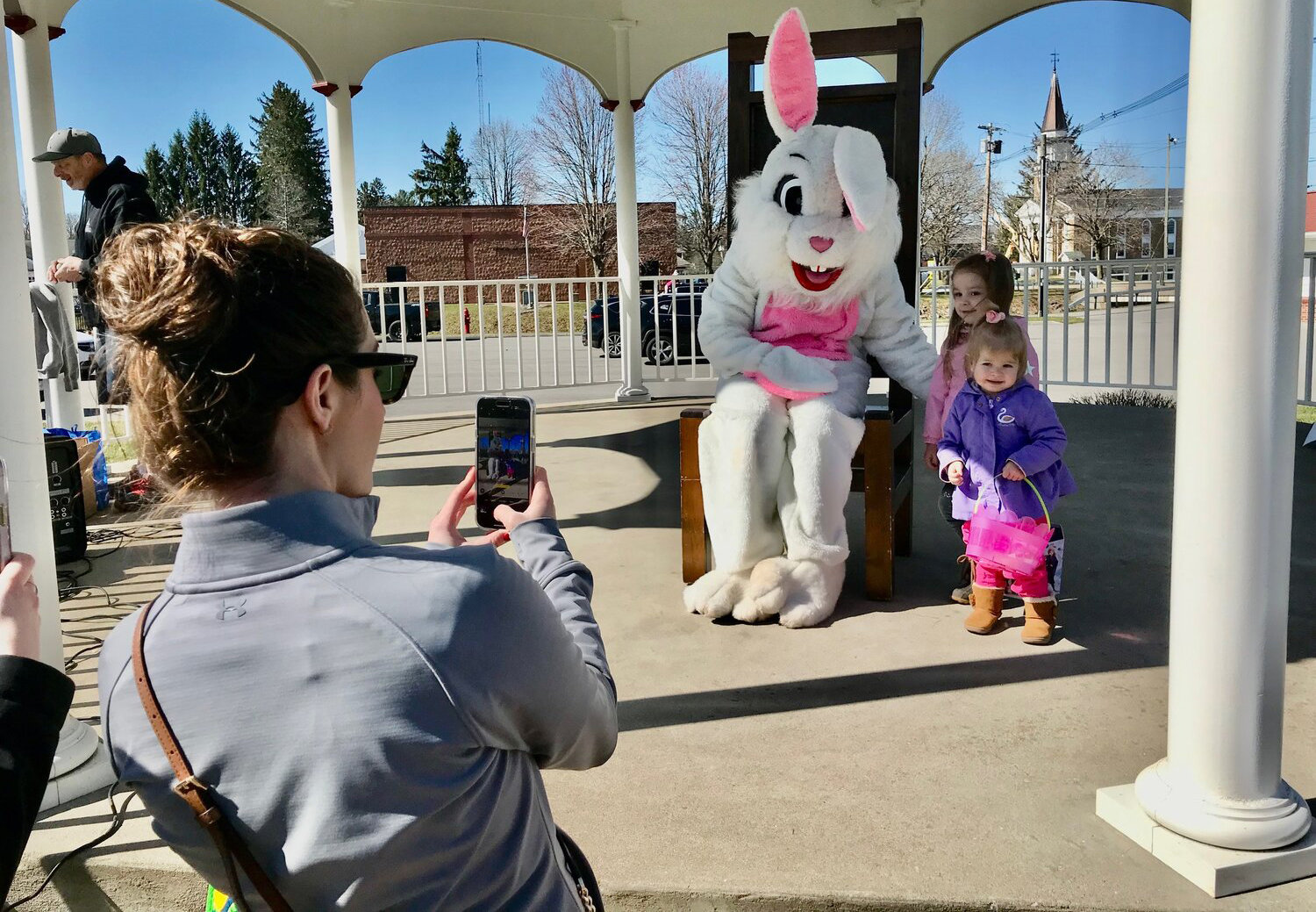 Jessica Yoxall, left, takes a picture of daughters Lauren and Payton with the Hop the Bunny Saturday, April 8 in Sherrill.