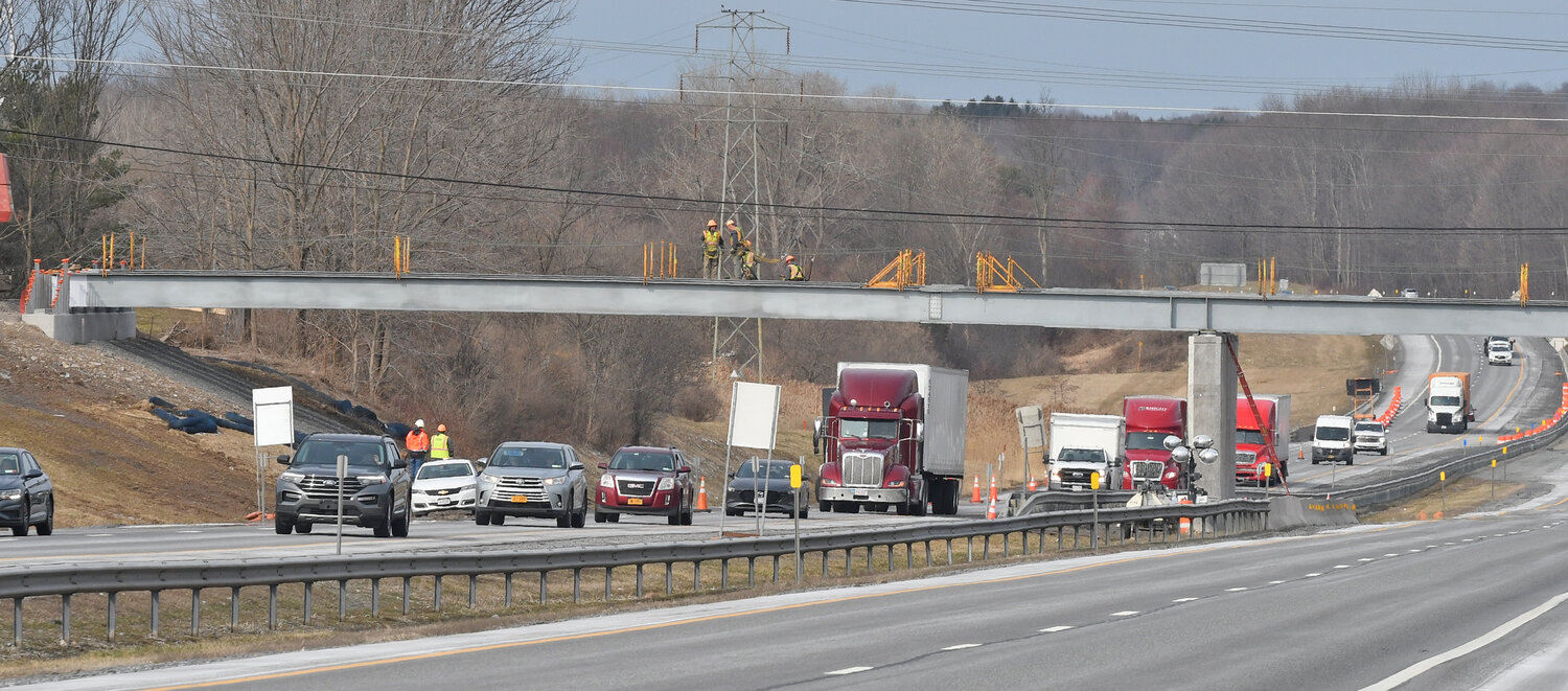 Steel workers on the steel beams that completes Route 840 span over the NYS Thruway on Friday, March 31.
