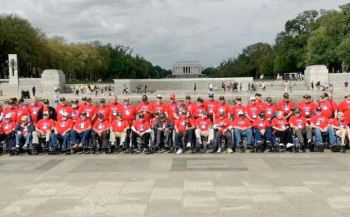 Veterans pose in front of one of the memorials with the Lincoln Memorial in the background while on the Honor Flight trip.