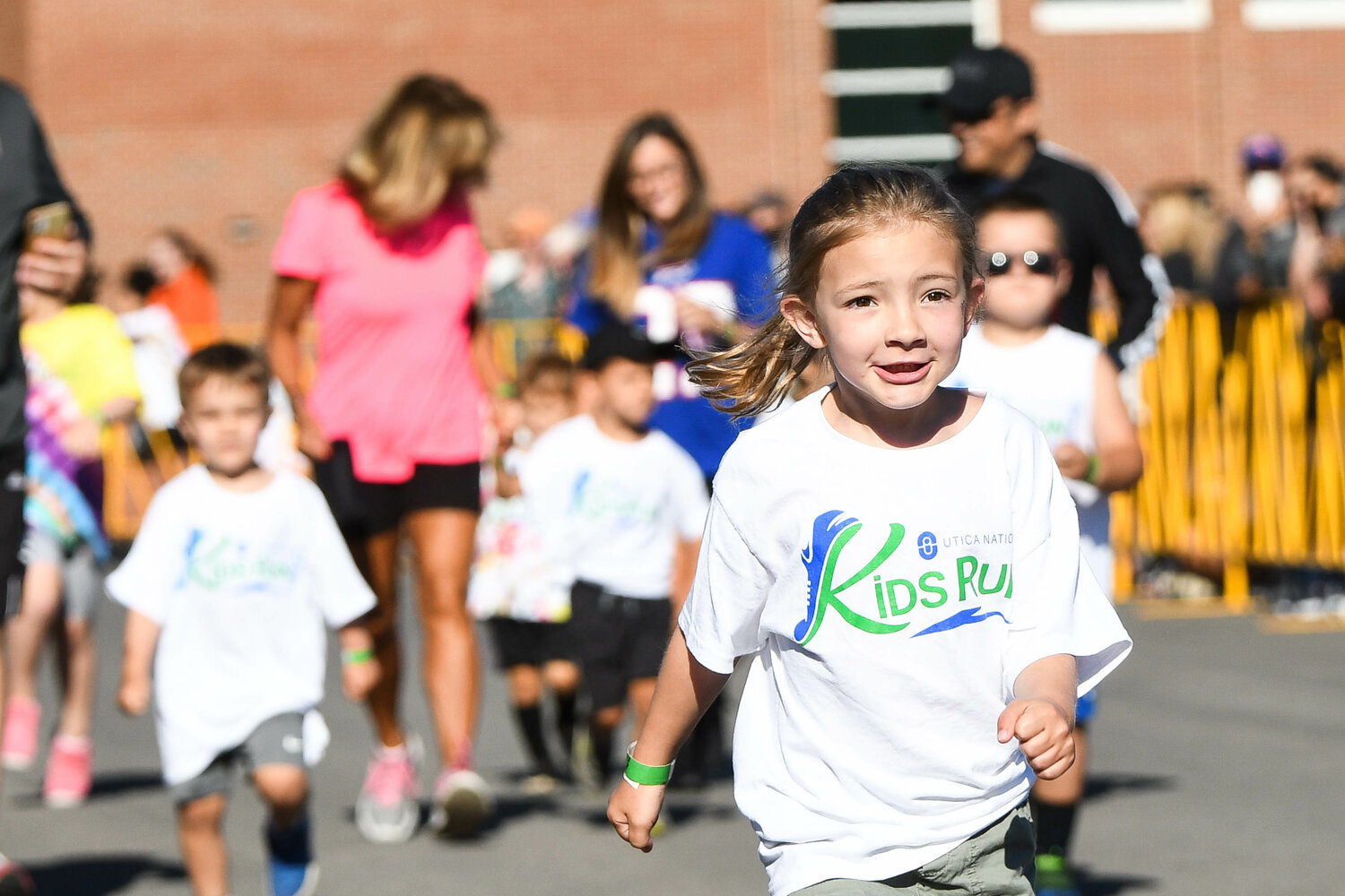 A young girl sprints toward the finish line during the 2022 Kids Run. The event takes place during Boilermaker Road Race weekend in Utica.