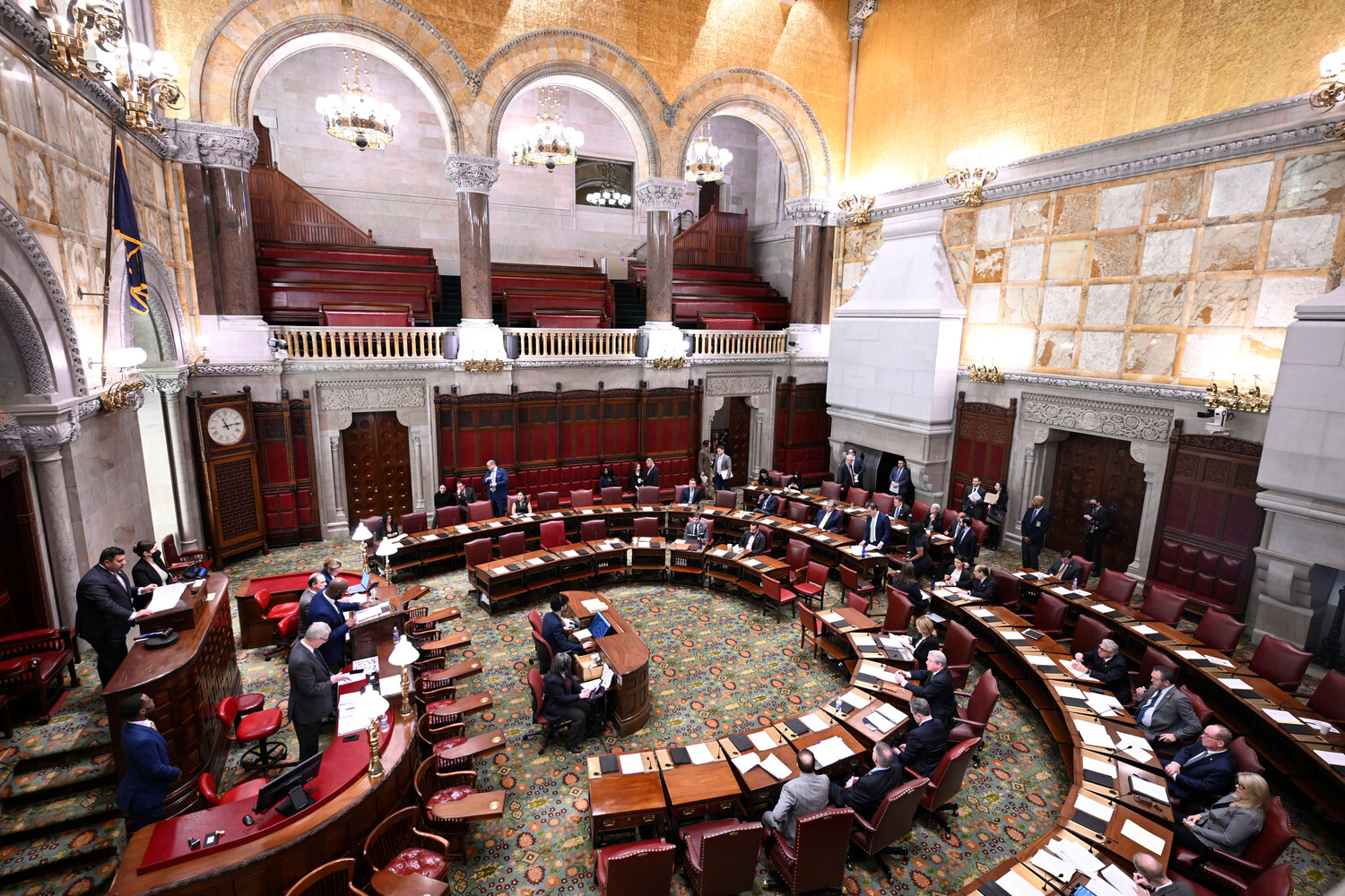 Members of the New York Senate work on legislative bills in the Senate Chamber before Gov. Kathy Hochul presents her executive state budget at the state Capitol on Feb. 1, 2023, in Albany, N.Y. Lawmakers in Albany passed a $229 billion spending plan late Tuesday, May 2, 2023, that will increase the statewide minimum wage, tweak the state's bail laws, and curb illegal and unlicensed pot shops.