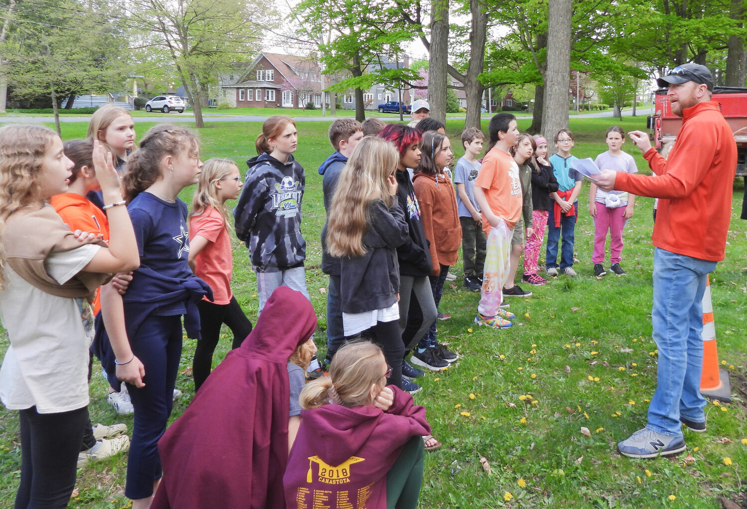 Parks and Recreation Director Luke Griff speaks to Seneca Street Elementary students about Arbor Day and asks them questions about the benefits of trees at an Arbor Day tree planting ceremony on Friday, May 5