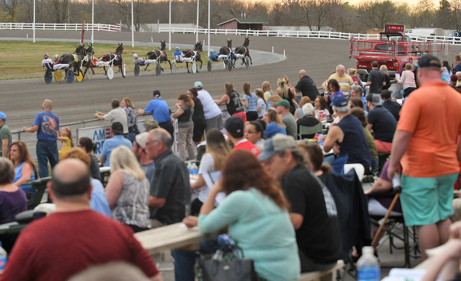 A crowd of over 1,700 spectators watch a race at Vernon Downs on Saturday, April 15, during the historic racetrack’s 70th season opener.