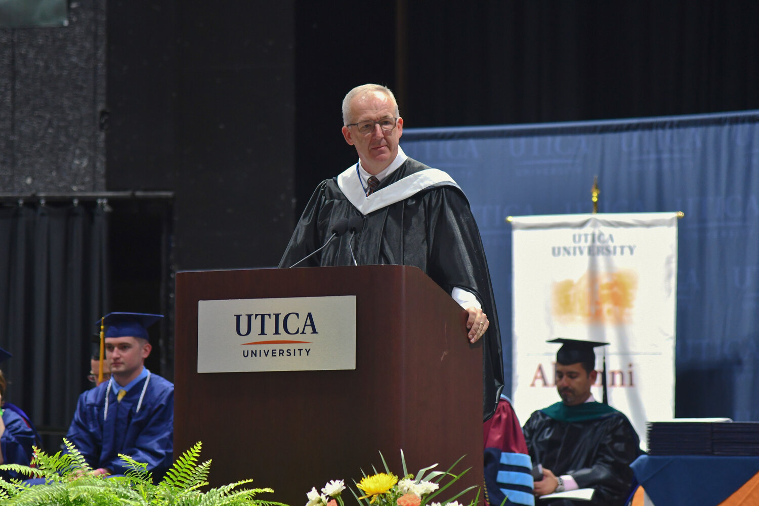 Greg Sankey gives the commencement address for Utica University's undergraduate ceremony on Thursday at the Adirondack Bank Center. Sankey, who is the Southeastern Conference (SEC) commissioner, worked at Utica University as the intramural director for two years in the late 1980s.