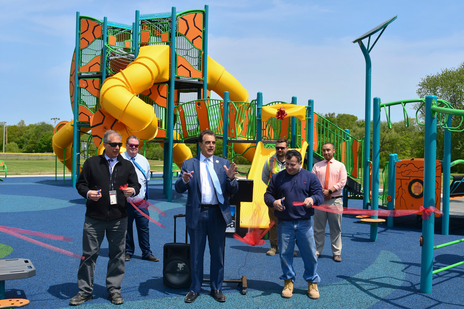 Utica city officials cut the ribbon at the newly-built inclusive playground at T.R. Proctor Park.