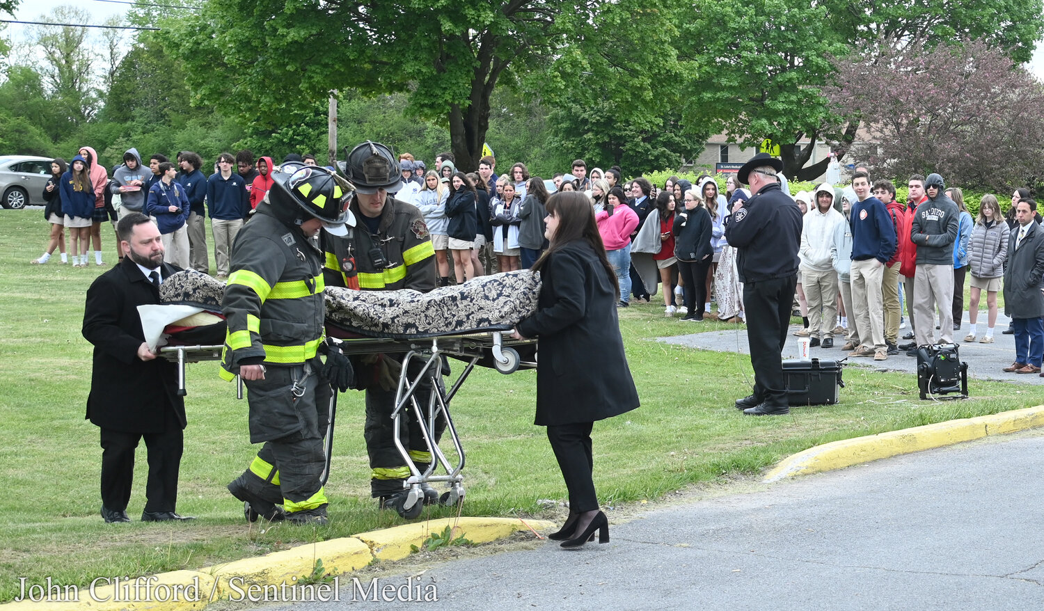 Students at Notre Dame Junior/Senior High School in Utica  had an up-close look at the potential tragic consequences of drunk driving  on May 17, 2023. In this photo, the "deceased" student actor with classmates in the background is loaded in to a hearse.
